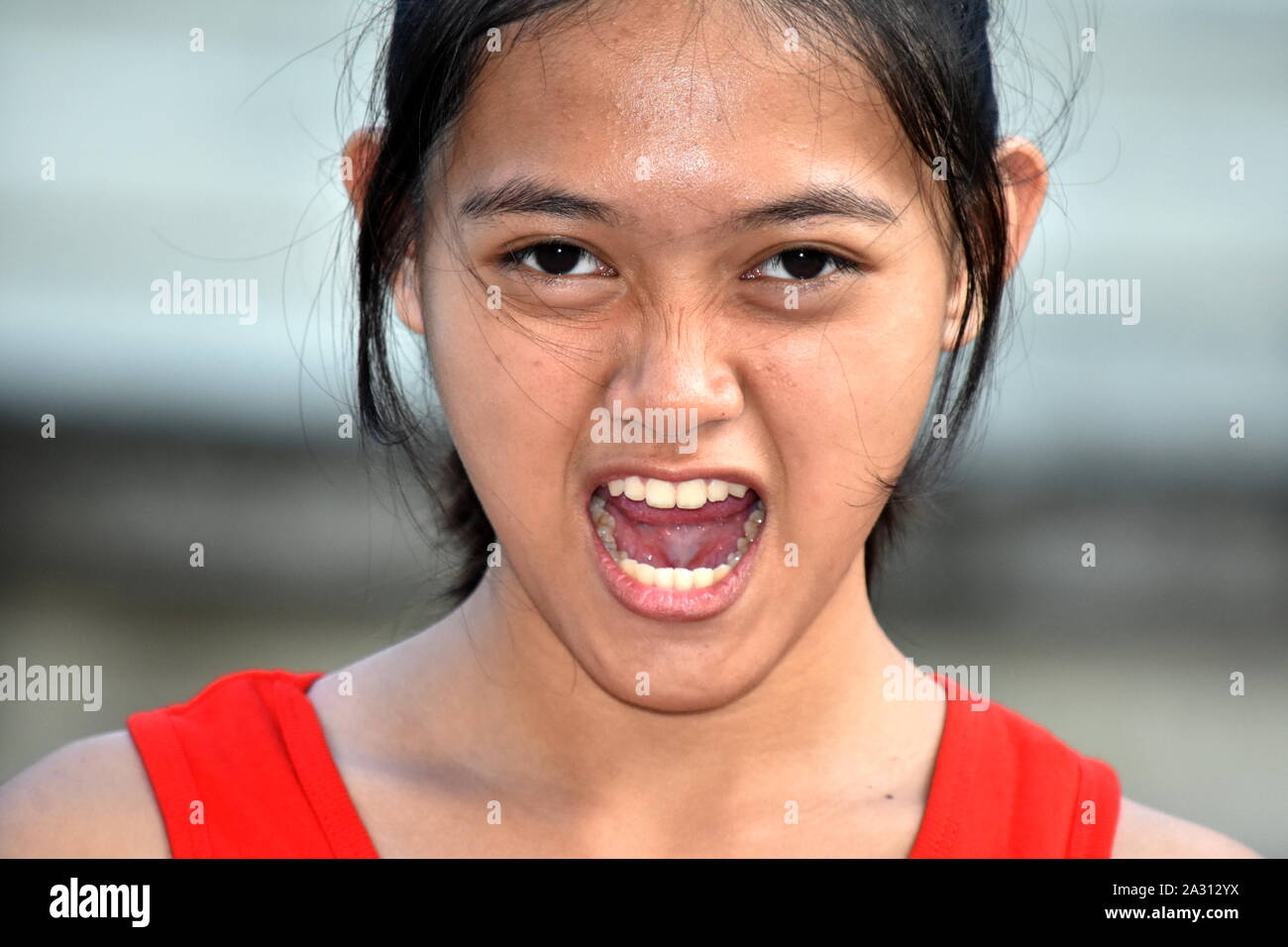 A Stressed Youthful Filipina Female Juvenile Stock Photo