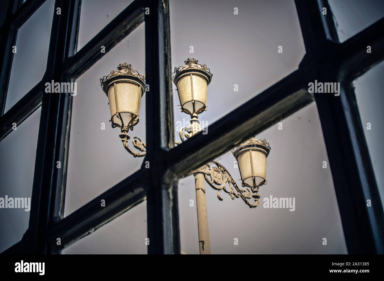 Streetlight (lamp post) through a window in a restaurant, Seville, Andalusia, Spain Stock Photo