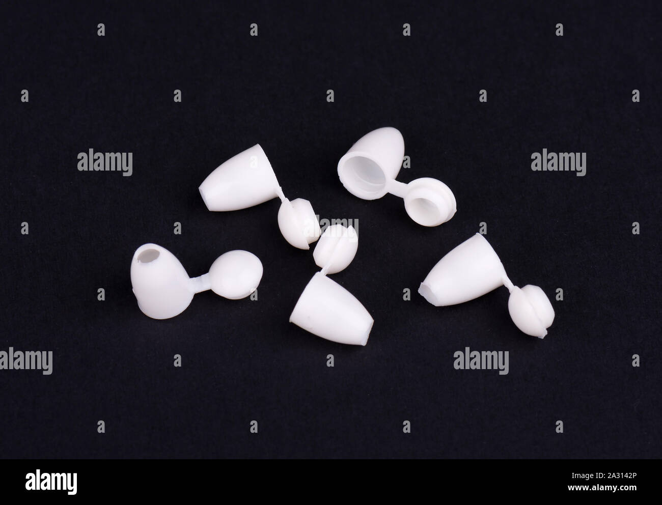 Plastic rivets for clothing. Sewing accessories on black background