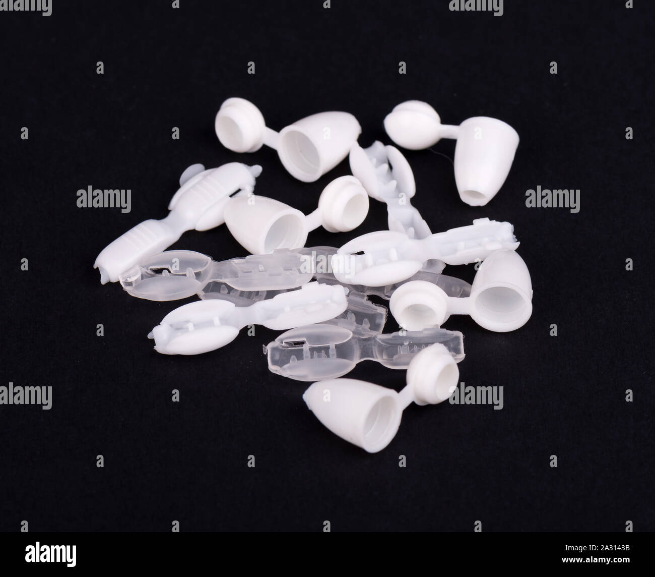 Plastic rivets for clothing. Sewing accessories on black background