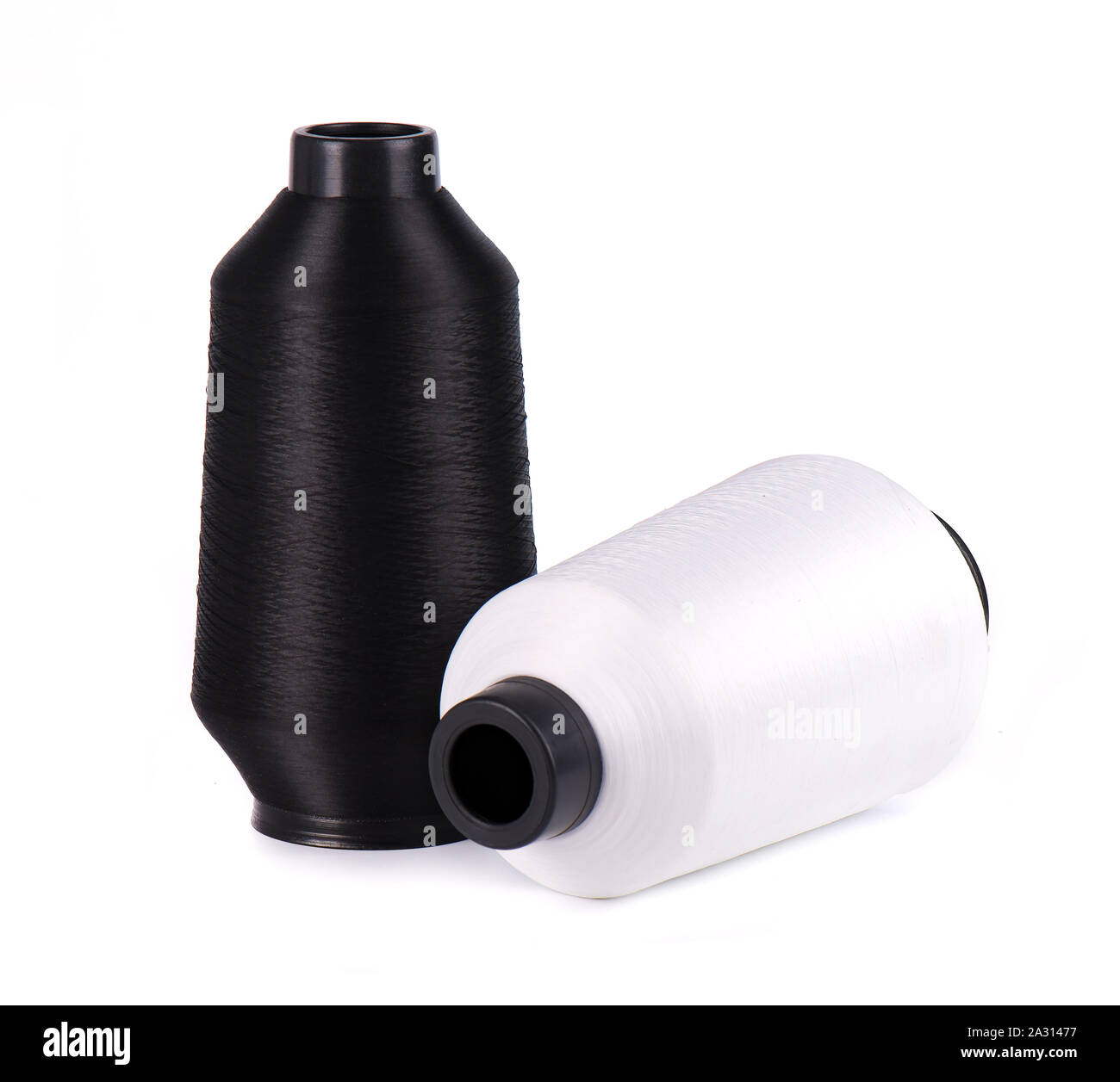 Sewing threads isolated on white background. White and black thread for ...