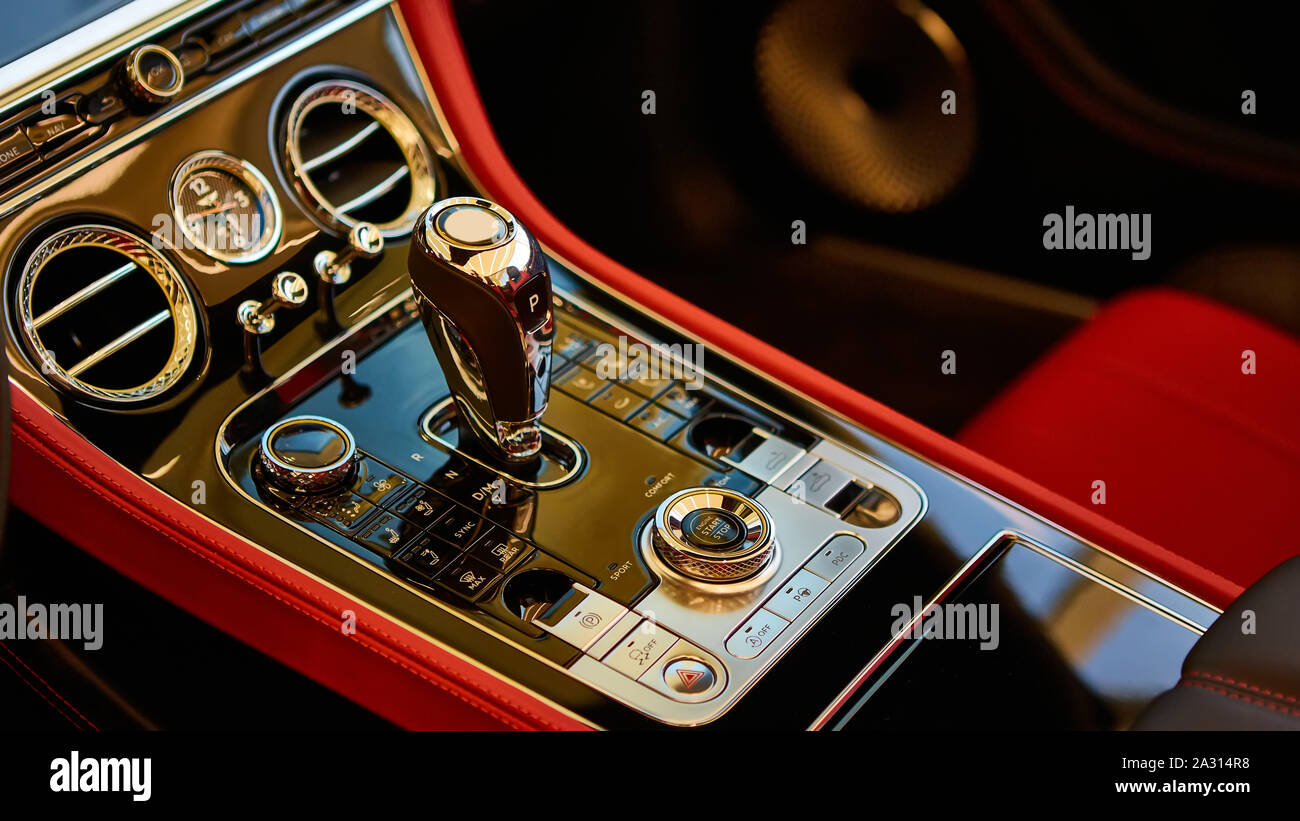 Automatic gear shift handle. Red luxury car Interior. Shallow doff. Stock Photo