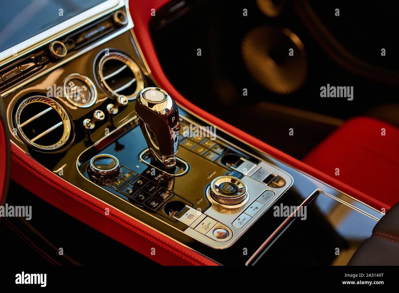 Automatic gear shift handle. Red luxury car Interior. Shallow doff. Stock Photo
