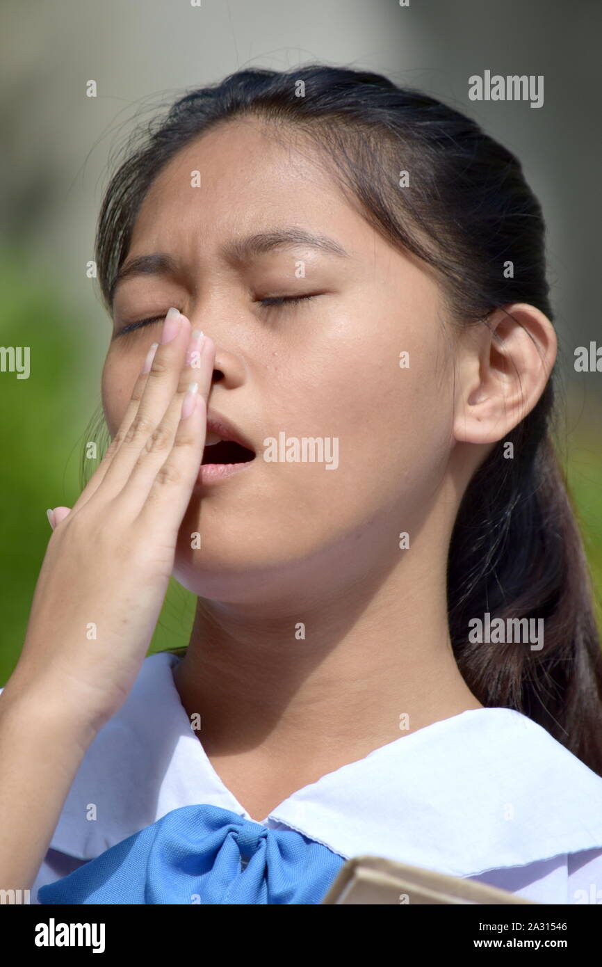 A Beautiful Asian School Girl Yawning Stock Photo