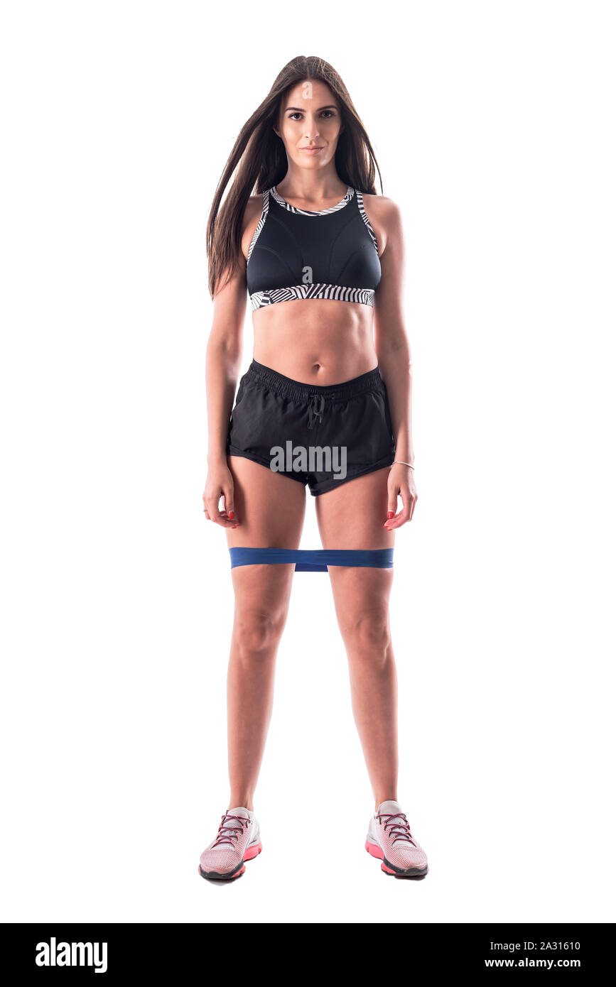 Proud athletic gym girl with great abs in top and shorts with resistance bands on legs. Full body isolated on white background Stock Photo Alamy