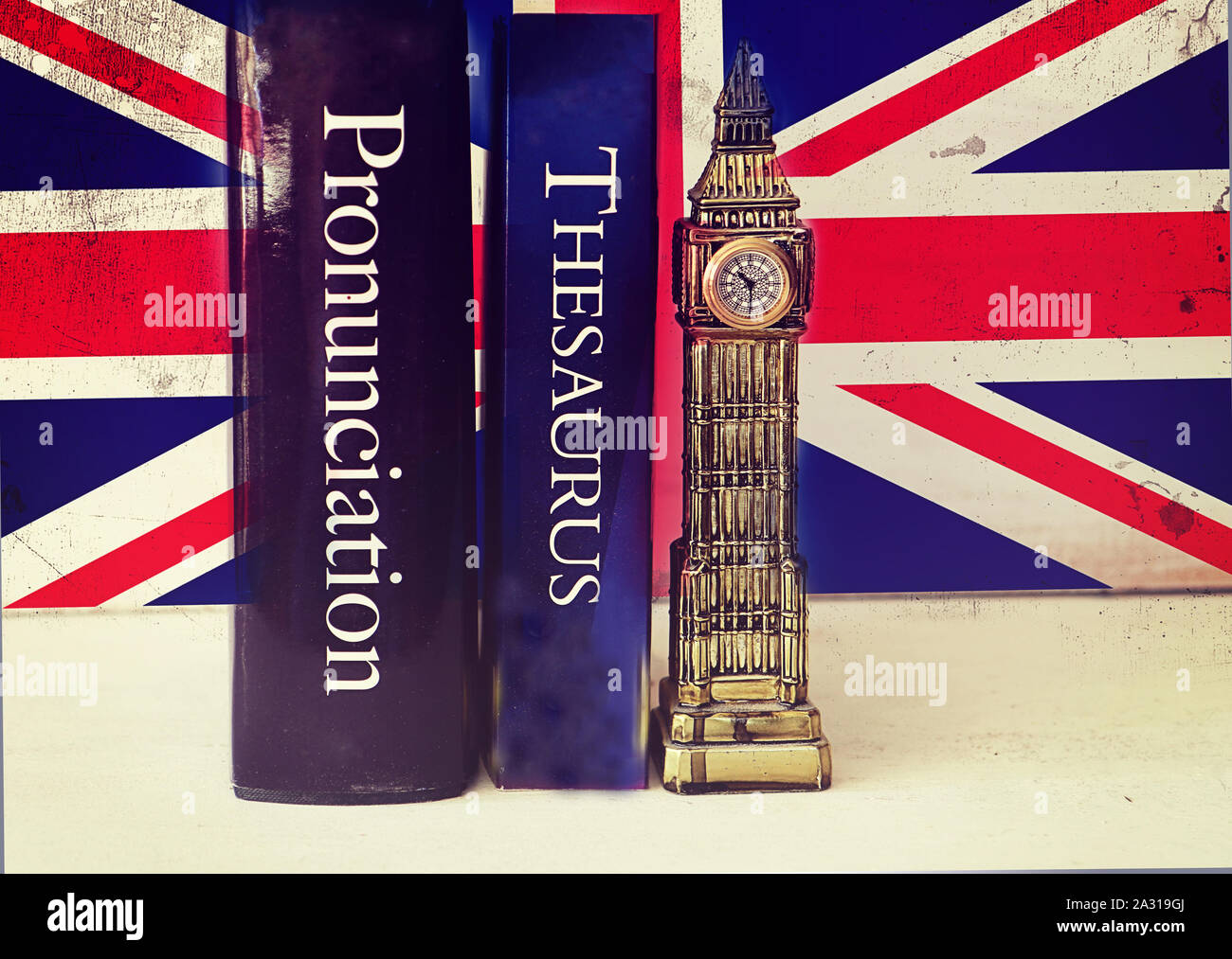 English language thesaurus and pronunciation dictionary near a tacky Big Ben reproduction on a grunge Union Jack background Stock Photo
