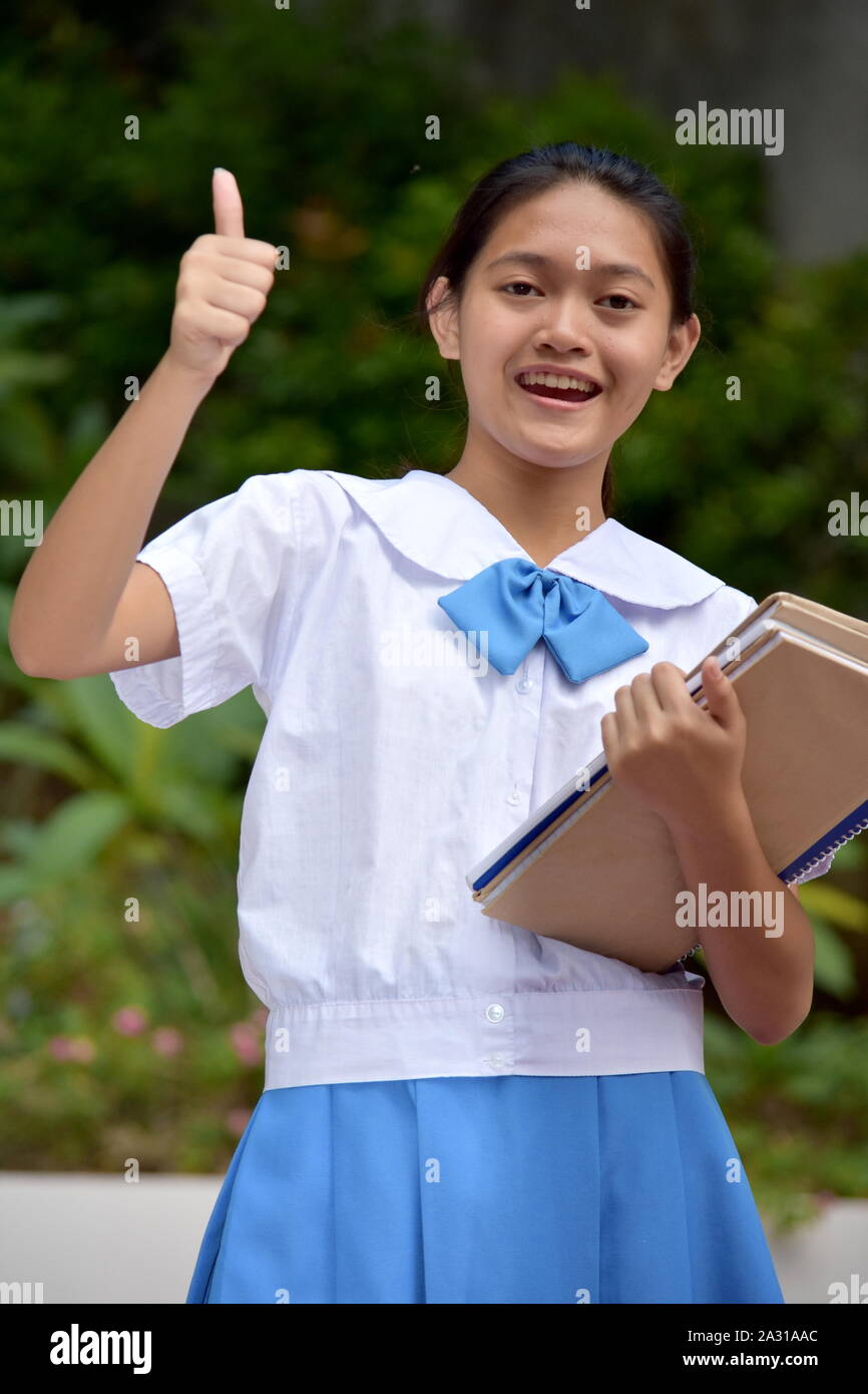 Youthful Minority Girl Student With Thumbs Up With School Books Stock ...