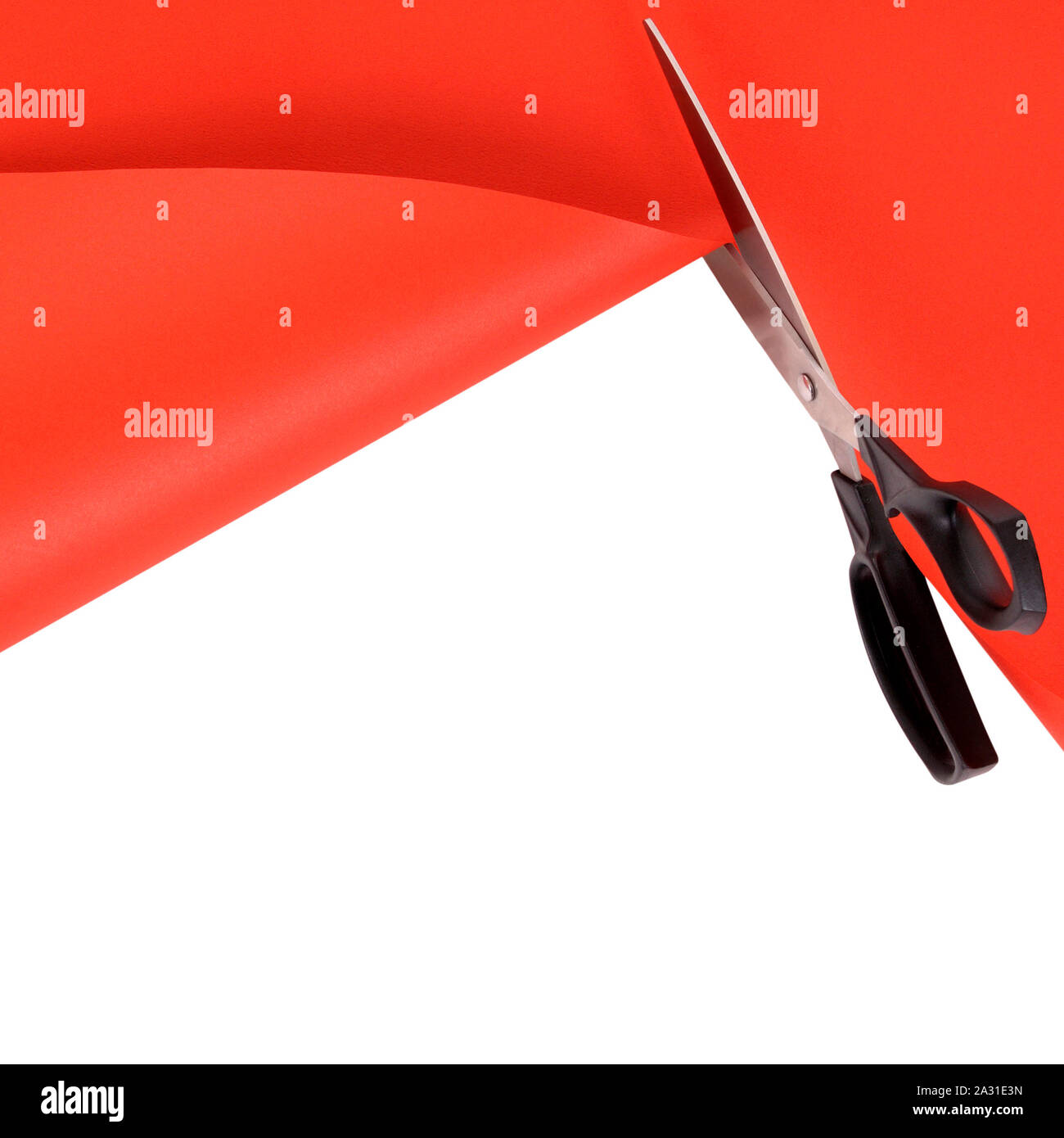 Scissors cutting red paper background Stock Photo