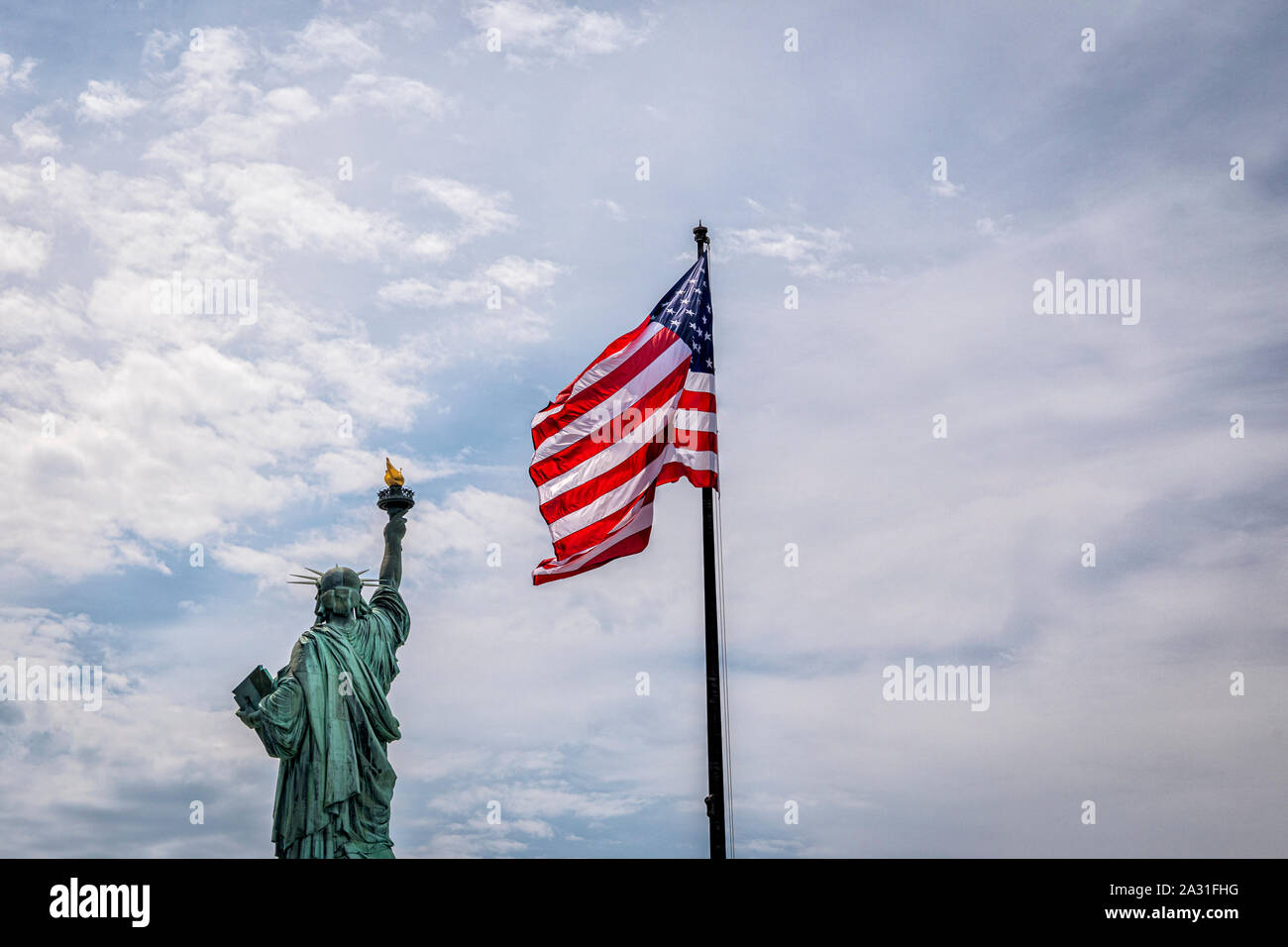 The Statue of Liberty and the US flag, New York City, USA. Stock Photo