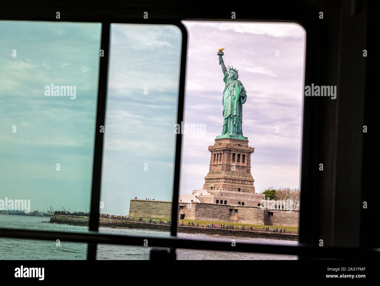 The Statue of Liberty seen through a window in the ferry, New York City