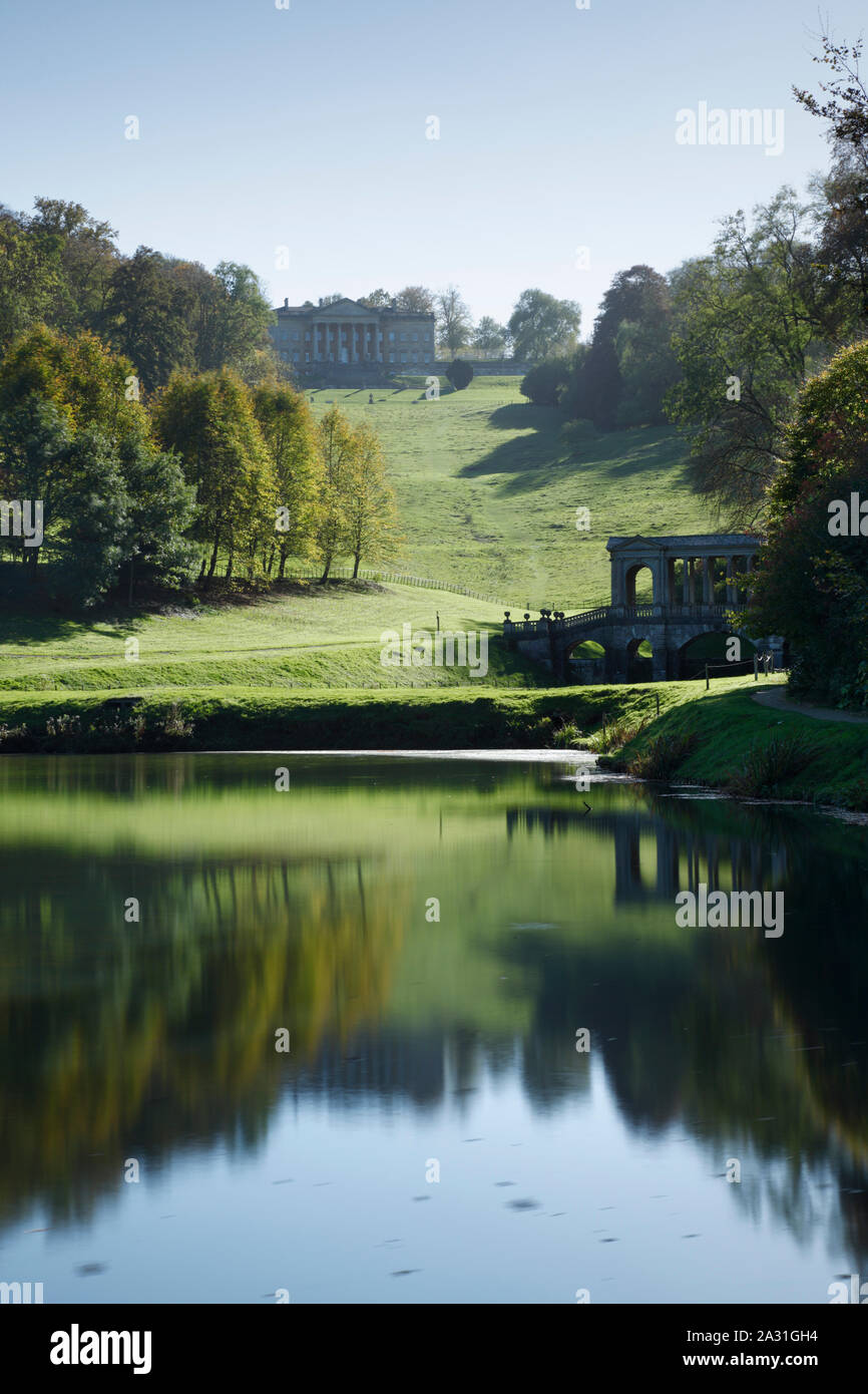 Prior Park Landscape Garden. View of the Palladian Bridge and the house from the lower lake. Bath. UK. Stock Photo
