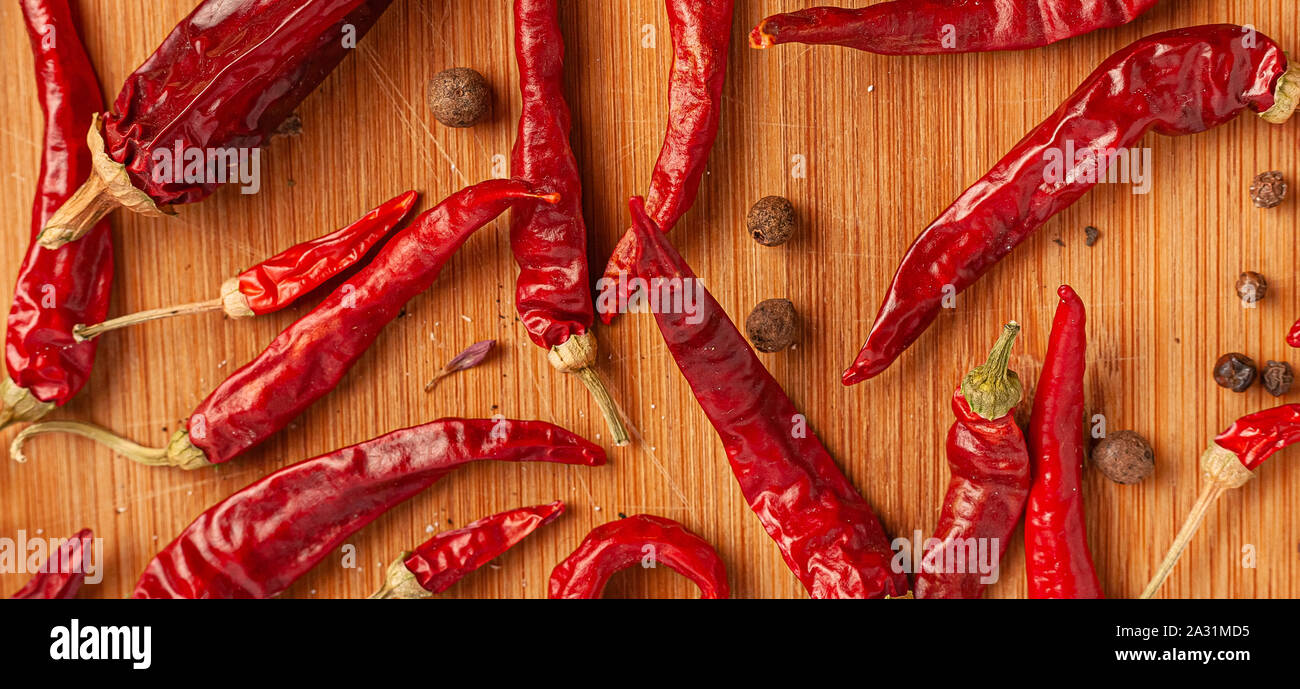 Red chili peppers on a wooden board Stock Photo - Alamy