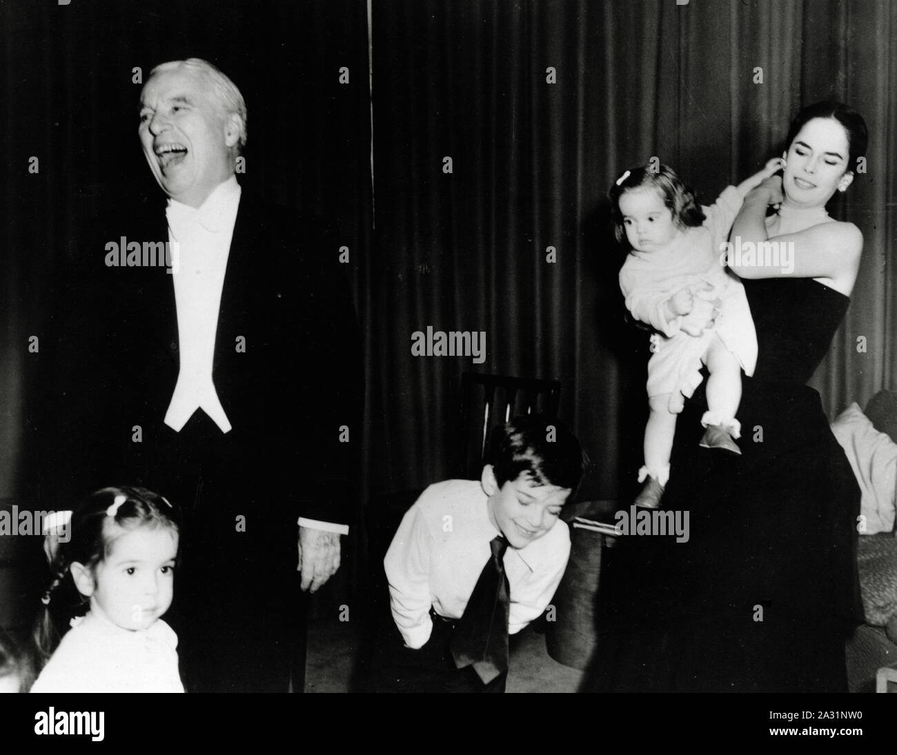 Charles Chaplin with his wife Oona and children (left to right) Josephine, Michael and Victoria, at the Savoy Hotel, London, circa 1953 Stock Photo