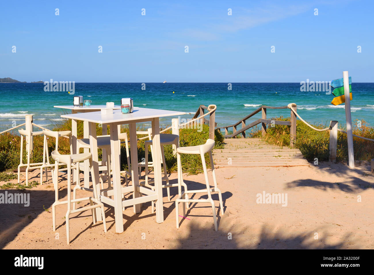 Table With Chairs In A Cafe Overlooking The Muro Beach Playa De