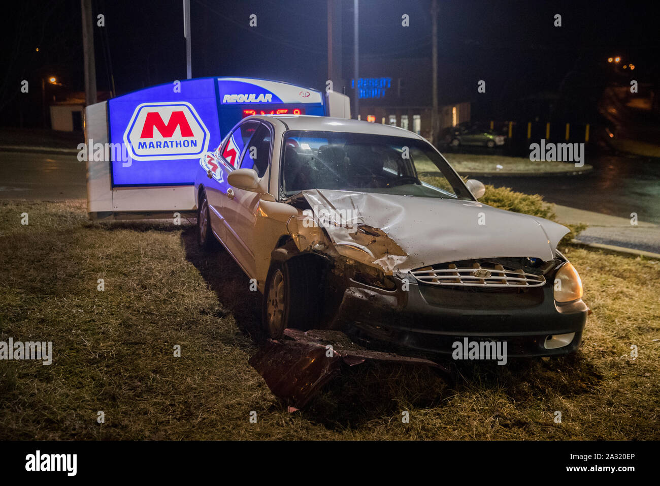 Police investigate at the scene of a car accident at the Marathon Gas station located at 1307 W 3rd St, before 2 a.m., Sunday, February 24, 2019 in Bloomington, Ind. The driver of the car fled the scene after hitting the sign, and police were looking for them in the area of Patterson. (Photo by Jeremy Hogan) Stock Photo