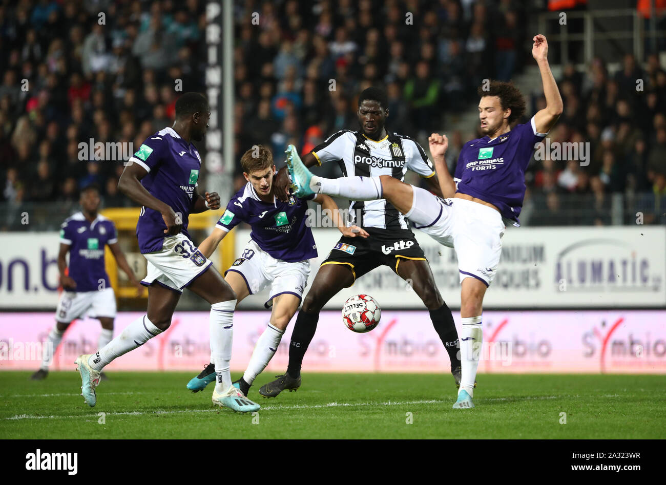 CHARLEROI, BELGIUM - OCTOBER 04: Sieben Dewaele of Anderlecht battles for  the ball with Shamar Nicholson of Charleroi and Philippe Sandler of  Anderlecht during the Jupiler Pro League match day 10 between