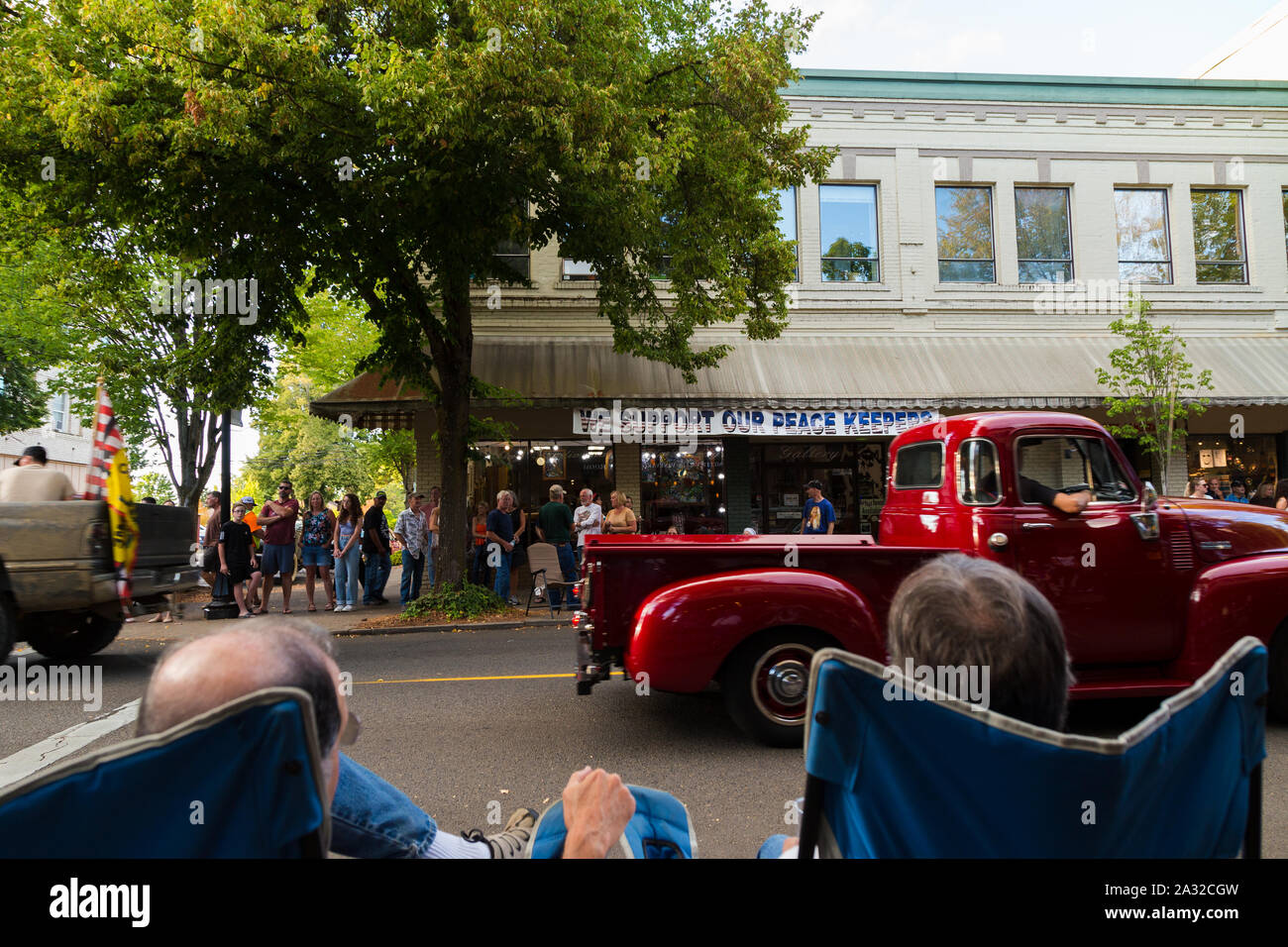 MCMINNVILLE, OR, USA - AUG 24, 2019: A vintage car rally in the center of downtown Mcminnville, OR, with a support our troops sign on a building. Stock Photo