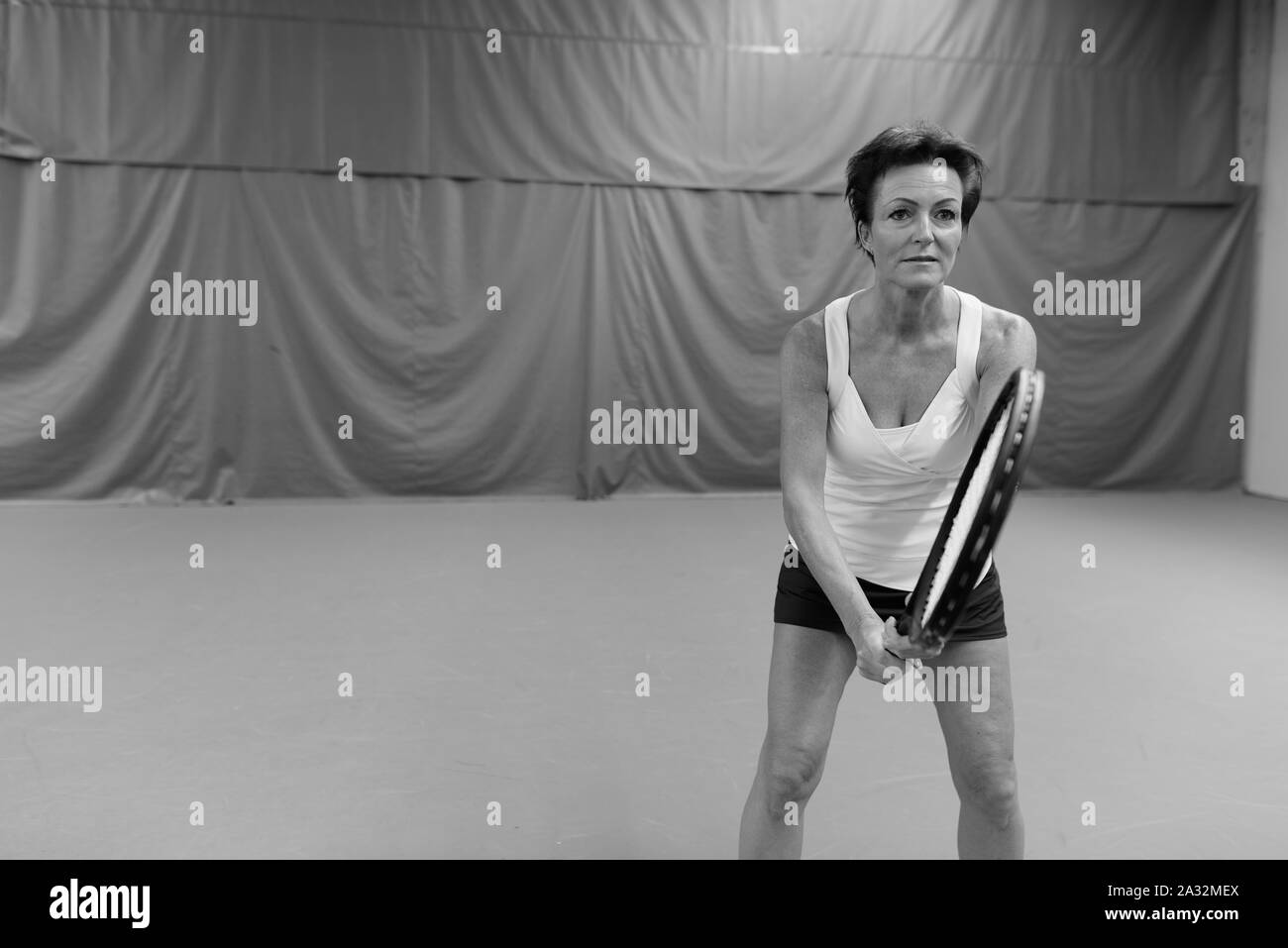 Mature woman playing tennis Black and White Stock Photos & Images - Alamy