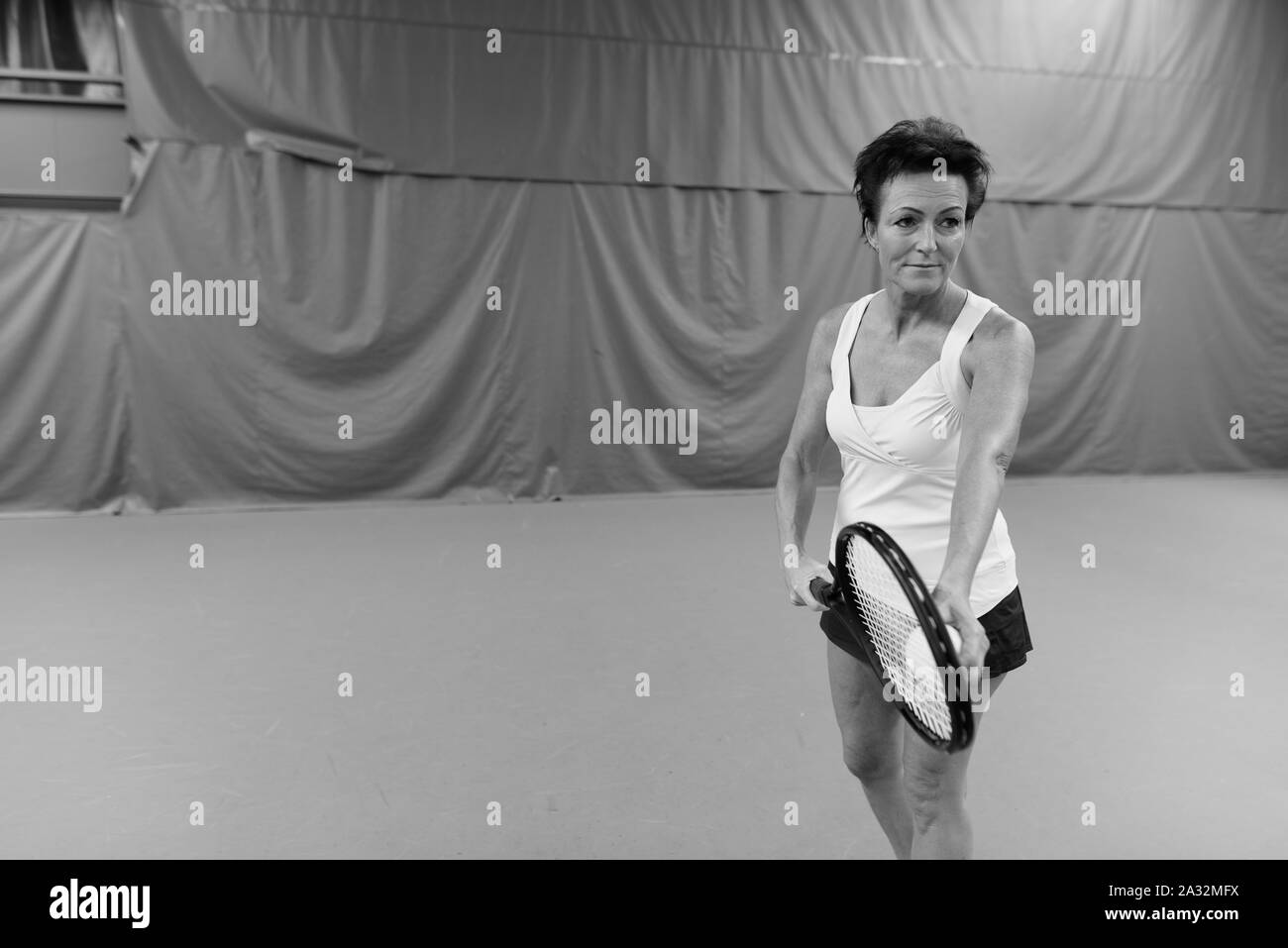 Mature woman playing tennis Black and White Stock Photos & Images - Alamy
