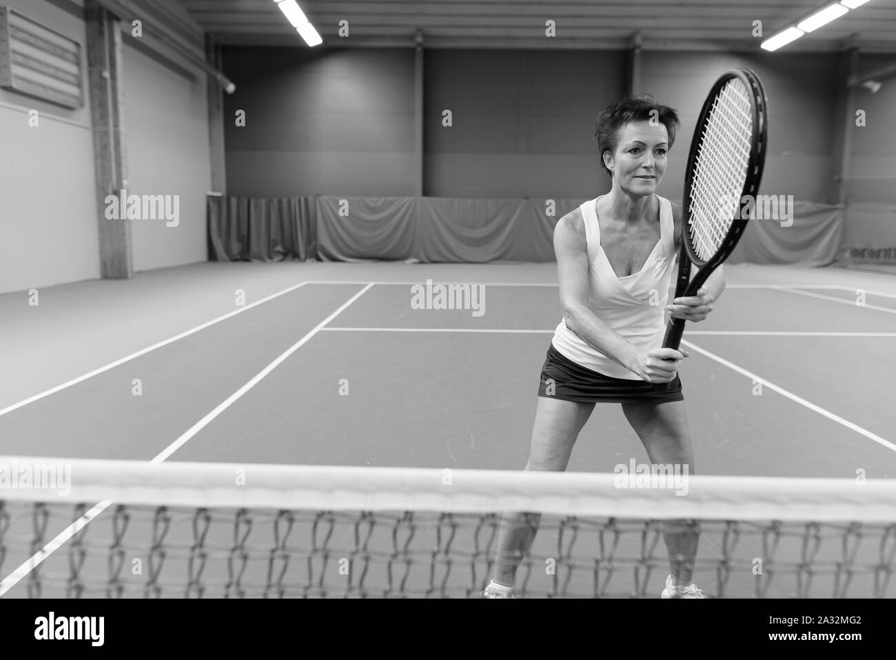 Mature woman playing tennis Black and White Stock Photos & Images - Alamy