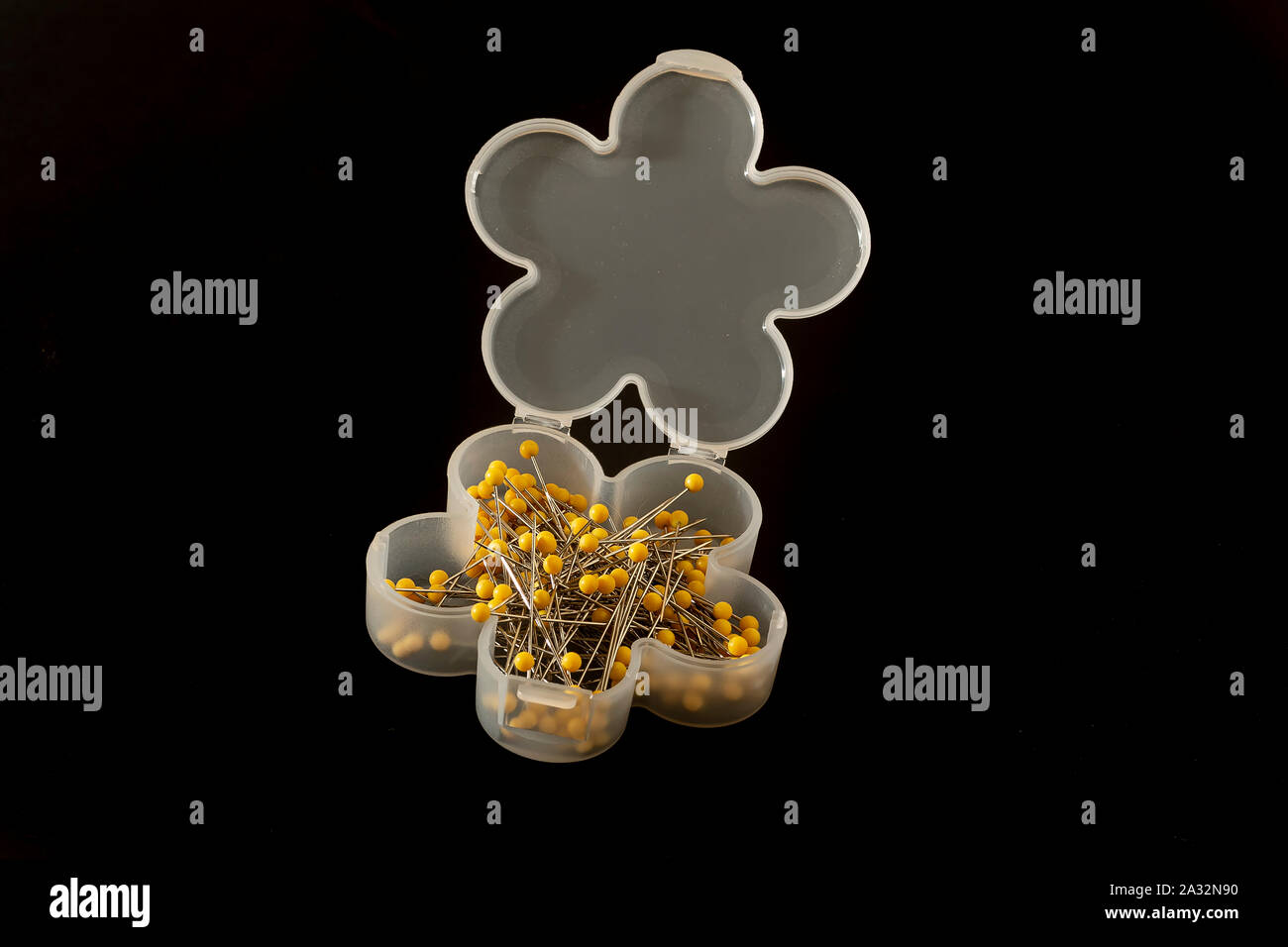 Tailor pins in a box on black background Stock Photo