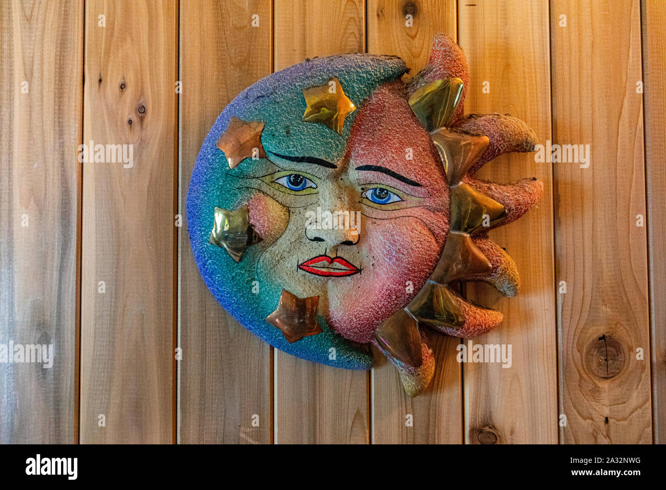 A close up view of a celestial sun, moon and stars representation on a