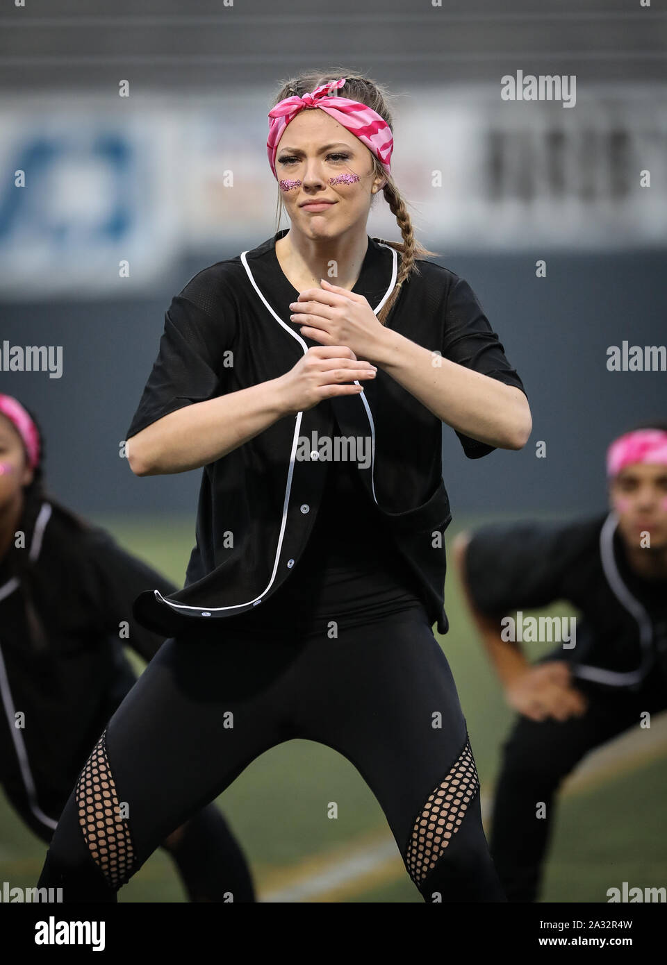 Cheerleaders and dancers from Rogers High School performing at 