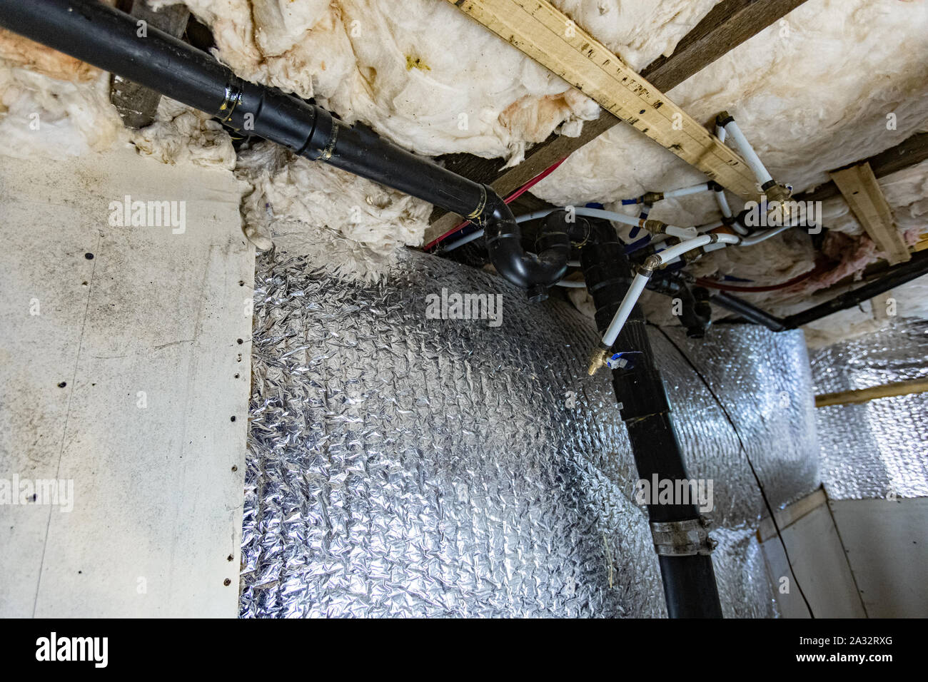 A low angle view on the walls, joists and structural details inside a