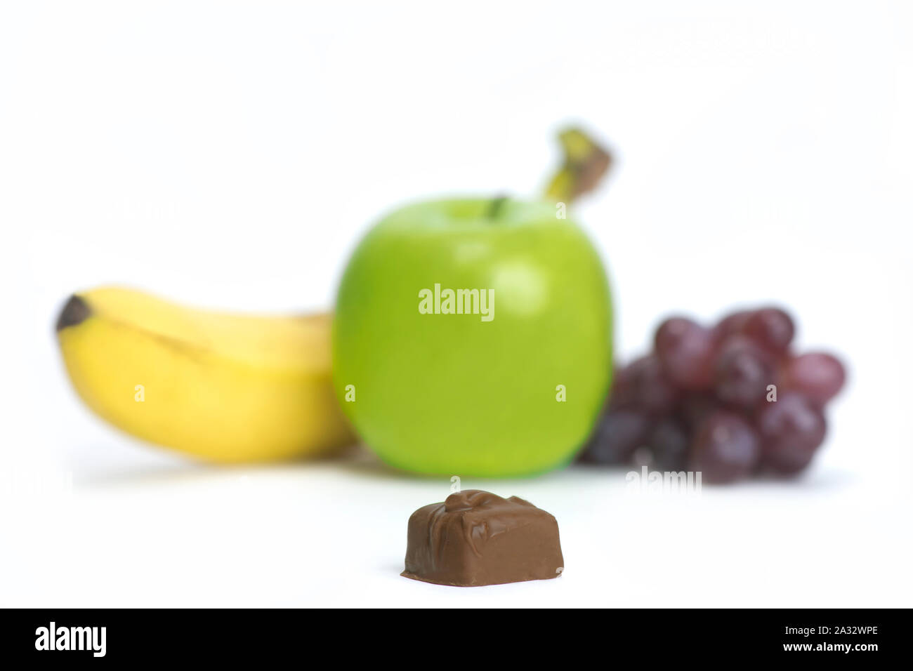 Food choice concept photo featuring chocolate vs fruit. Stock Photo