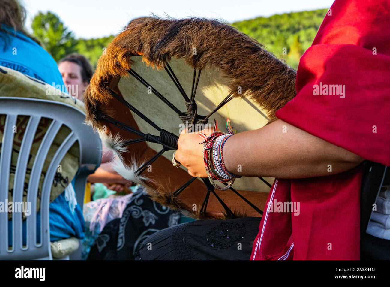A traditional handcrafted indigenous drum with fur edging is seen in ...