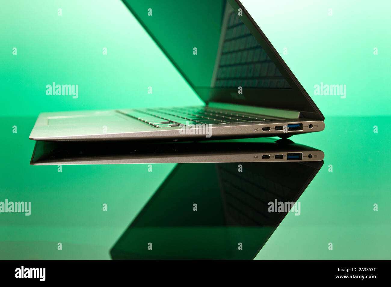 metal-finished laptop computer on reflective surface Stock Photo - Alamy