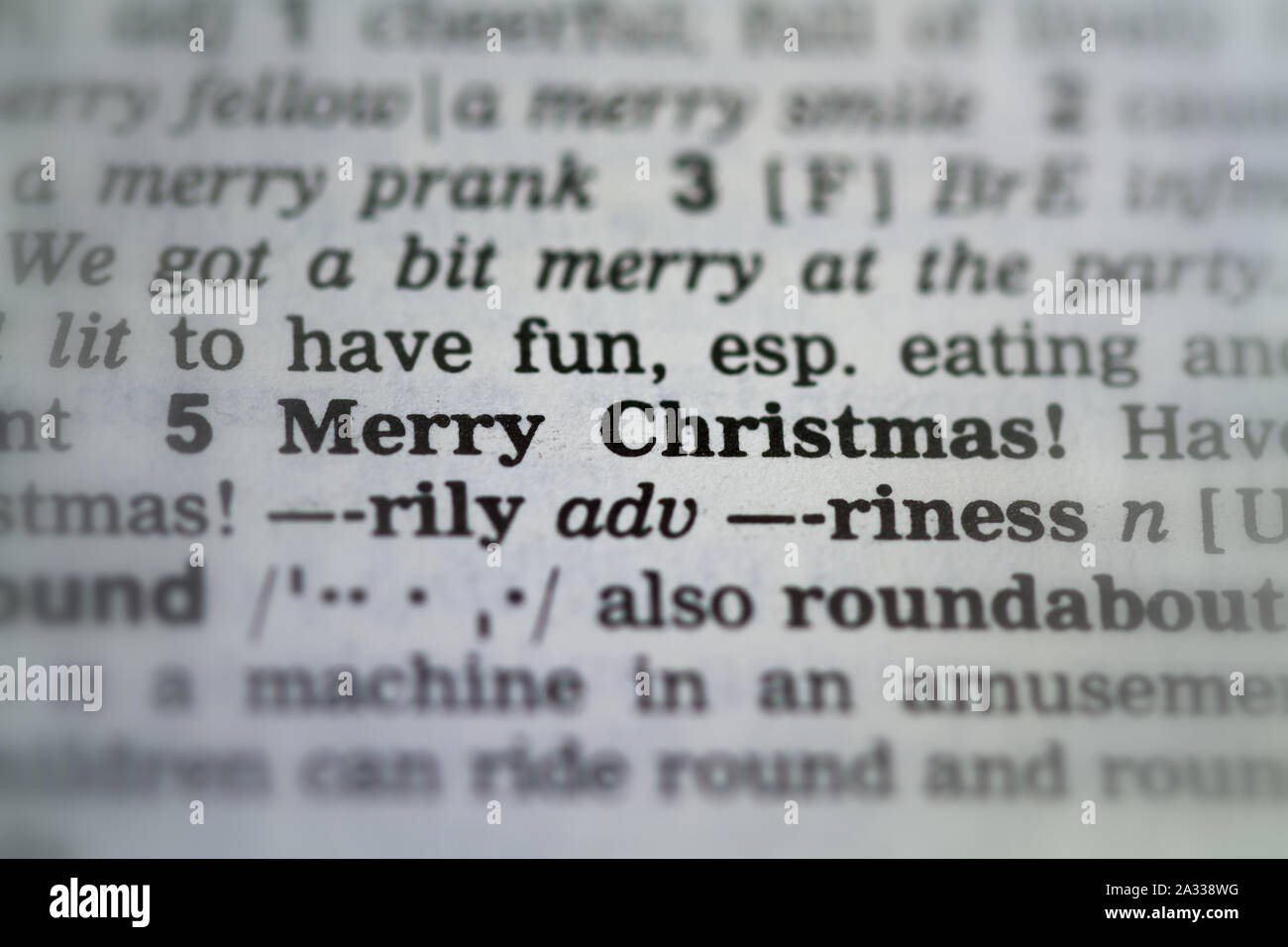 the word merry Christmas definition in old dictionary under magnifying  glass Stock Photo - Alamy