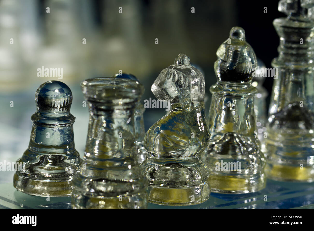 decorative glass chess set backlighted with dark background Stock