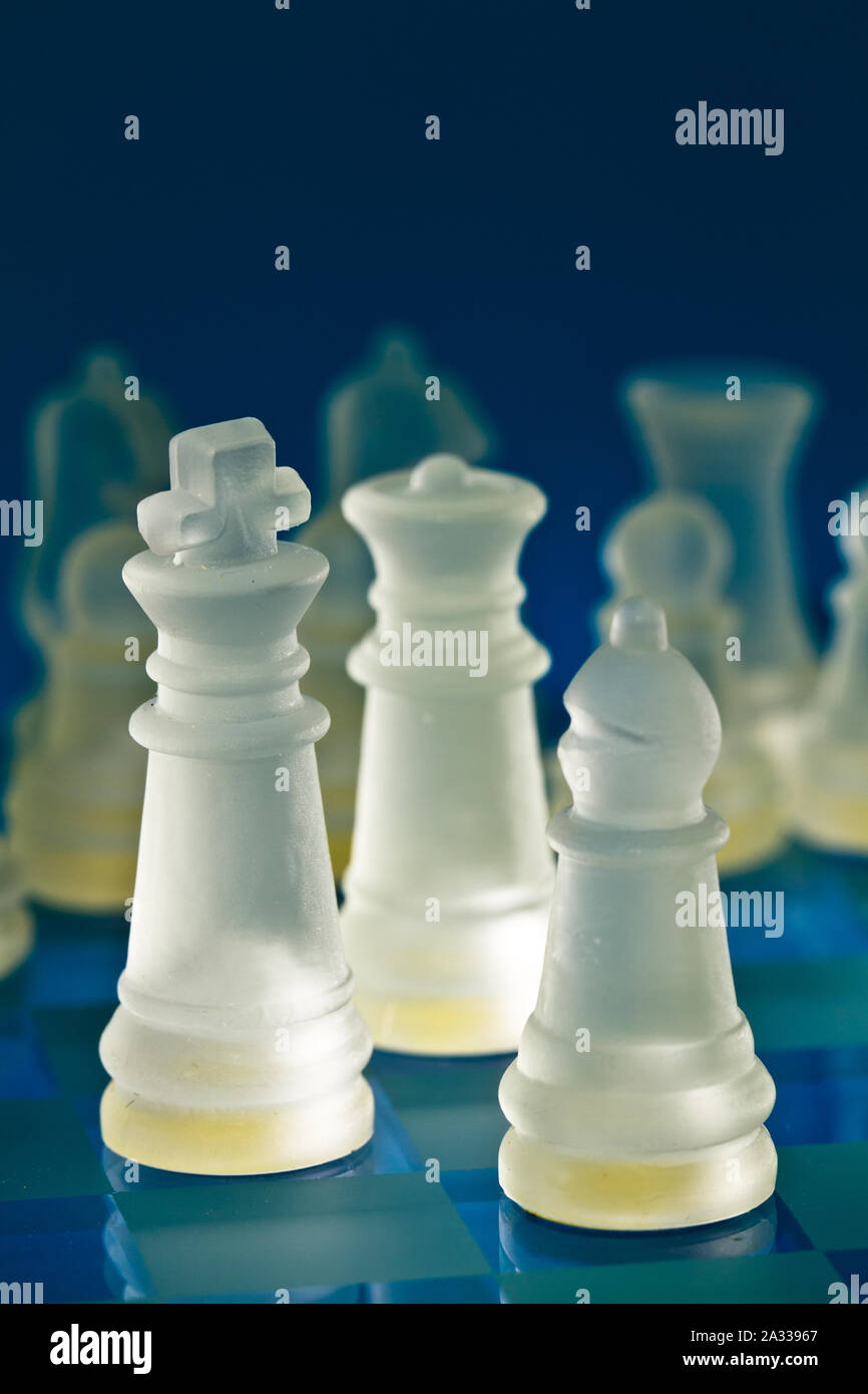 decorative glass chess set backlighted with dark background Stock