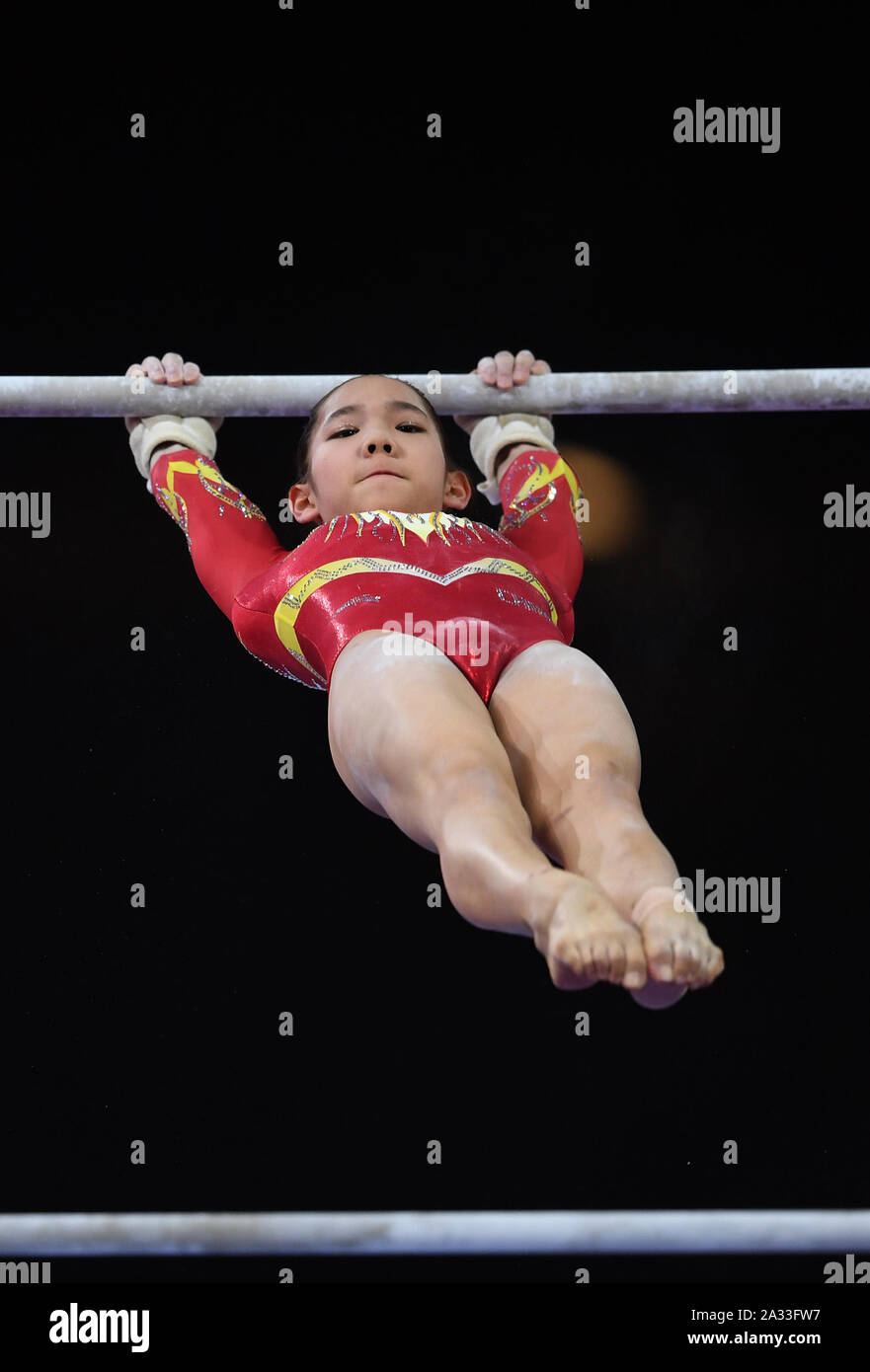 Stuttgart, Germany. 4th Oct, 2019. Tang Xijing of China competes on the uneven bars during the Women's Qualifications of the 2019 FIG Artistic Gymnastics World Championships in Stuttgart, Germany, Oct. 4, 2019. Credit: Lu Yang/Xinhua/Alamy Live News Stock Photo