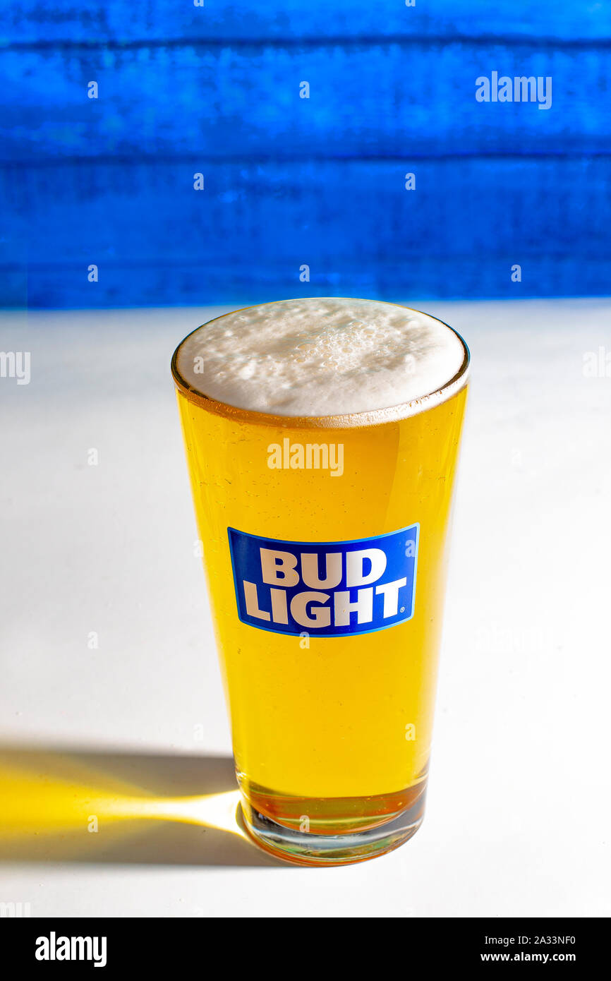 Calgary AB, Canada. October 1, 2019. Bud Light Pint Beer on a white table with a wooden wall. Stock Photo