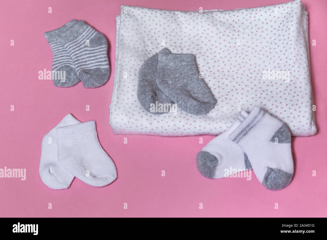 Baby socks for newborn girl or boy collected on a pink background