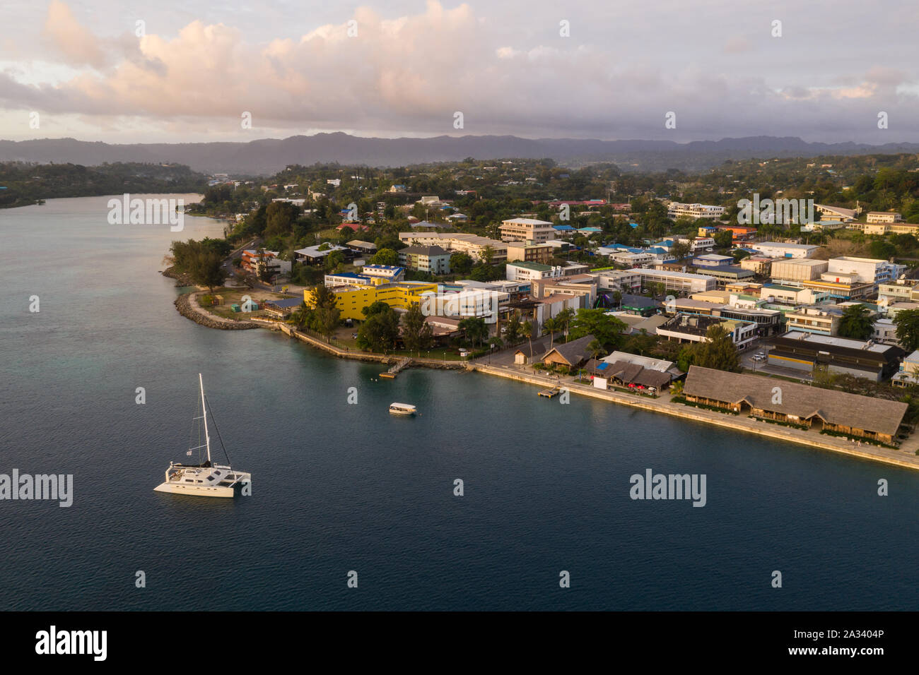 Port Villa waterfront and business district with catamaran in Vanuatu capital city in the south Pacific Stock Photo