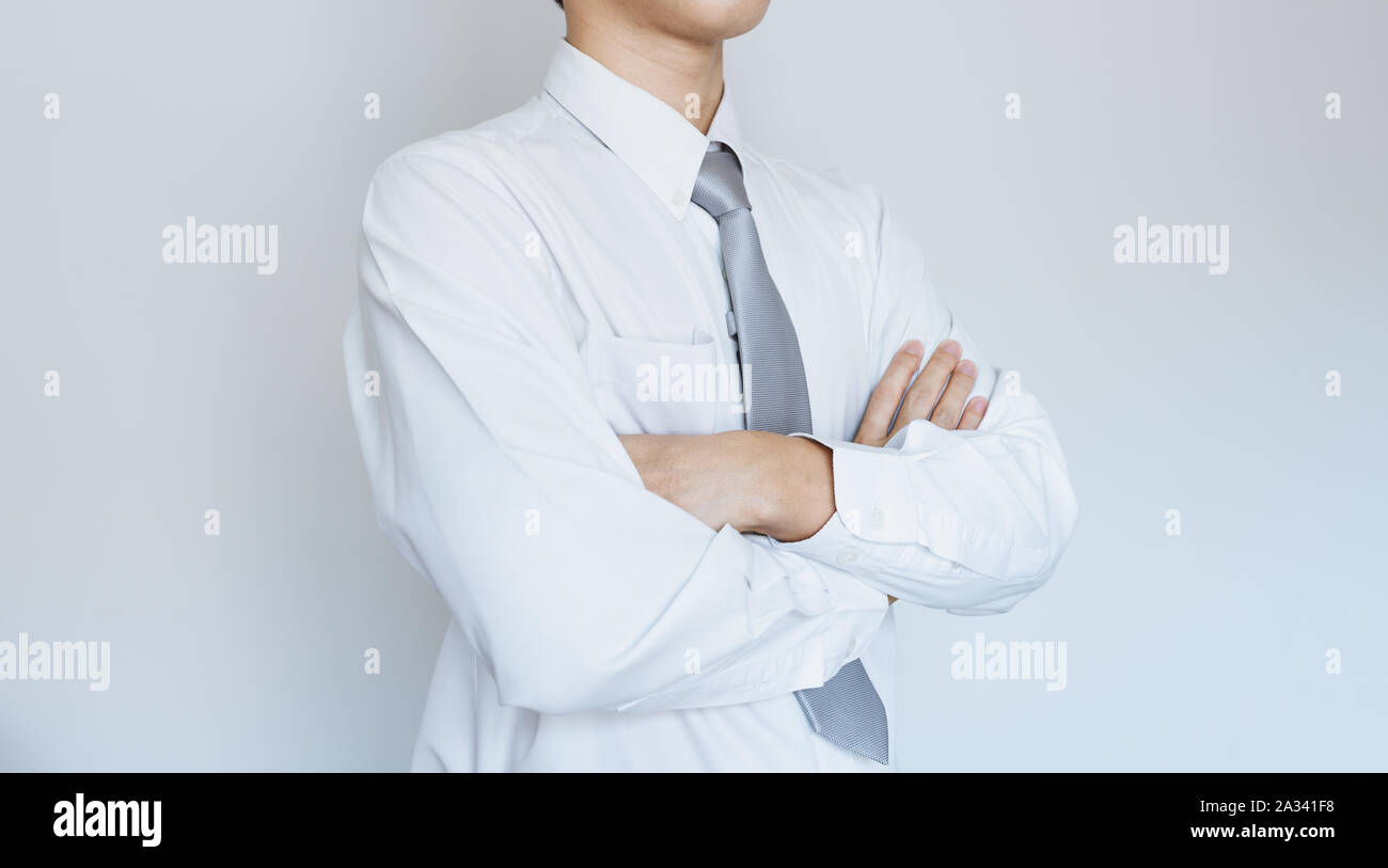 Business employee in white shirt with arm crossed Stock Photo