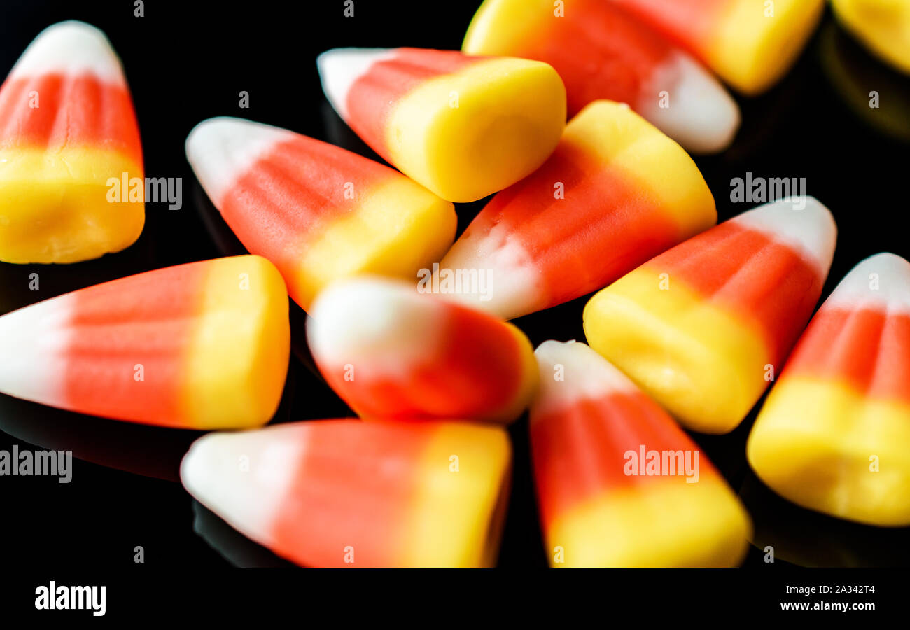 Closeup of Candy Corn Isolated on Black Background Stock Photo
