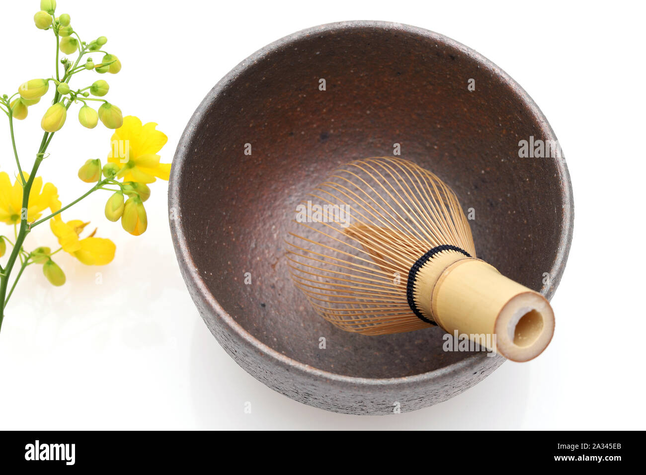 Empty tea bowl with tea whisk used in Japanese matcha tea ceremony on white hackgrond Stock Photo