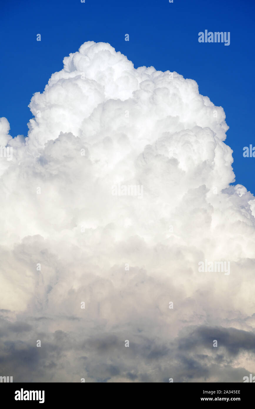 White cumulonimbus clouds in clear blue sky Stock Photo