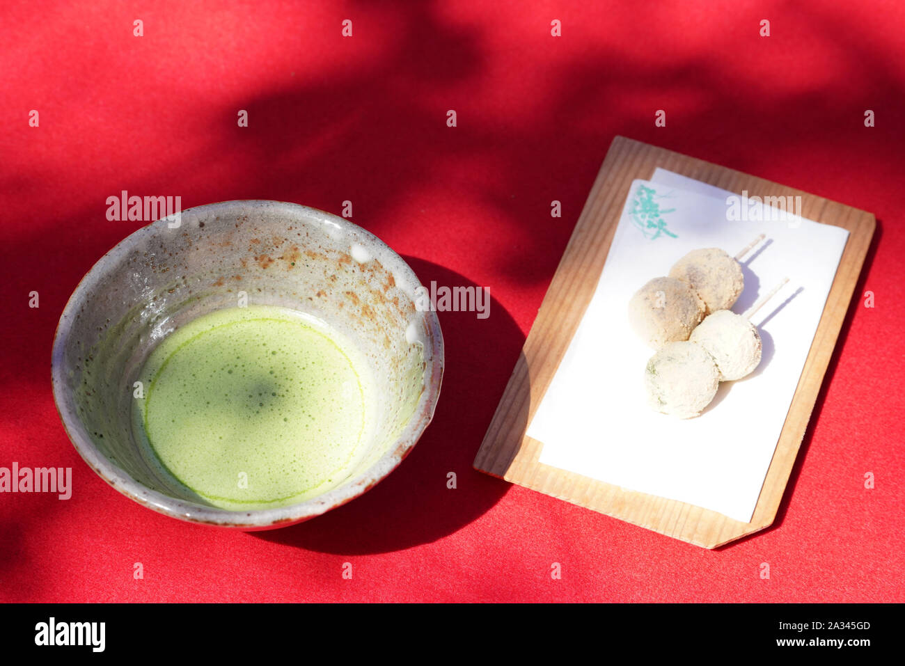 Japanese matcha green tea in a ceramic bowl with wagashi Stock Photo