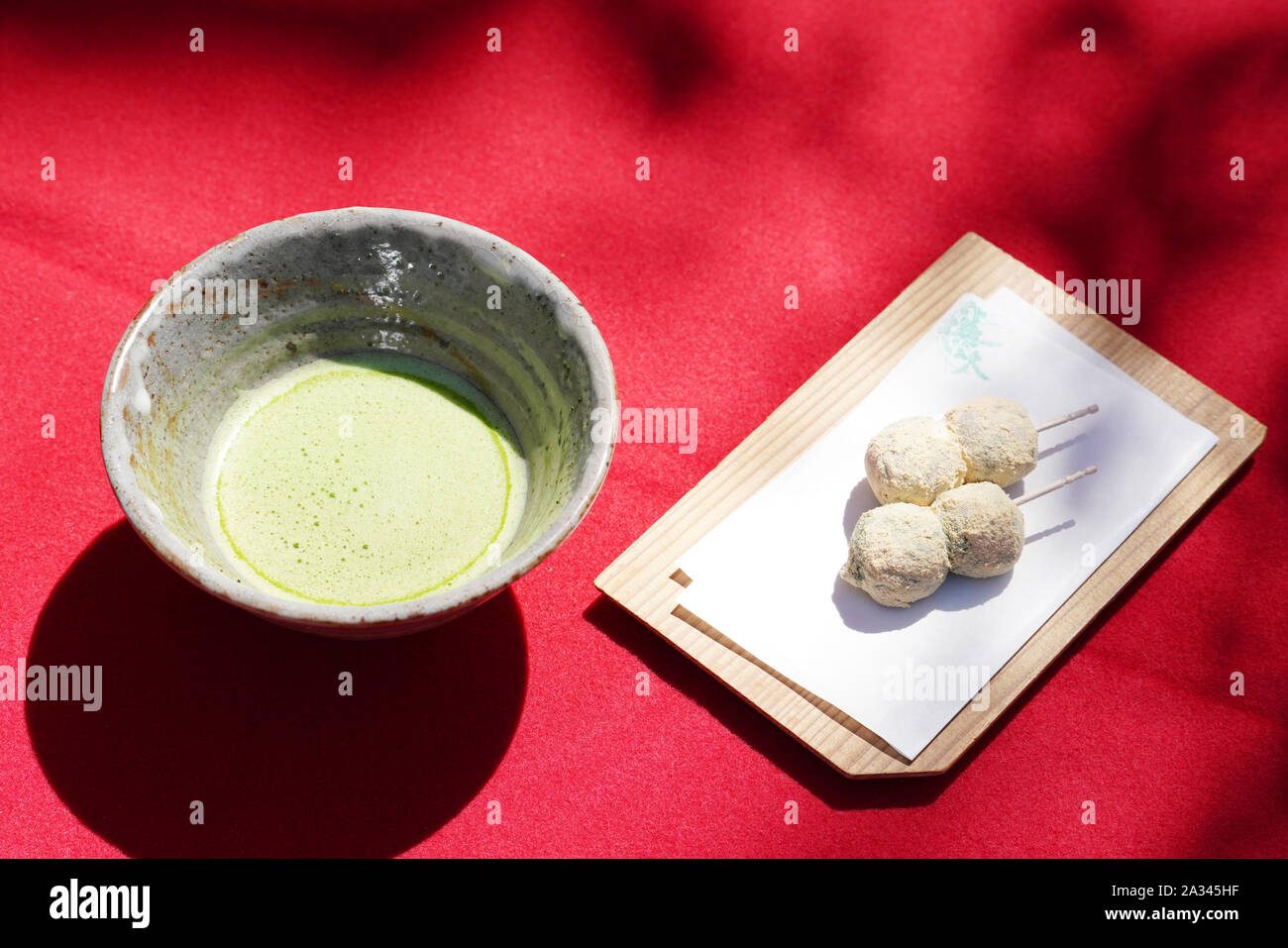 Japanese matcha green tea in a ceramic bowl with wagashi Stock Photo