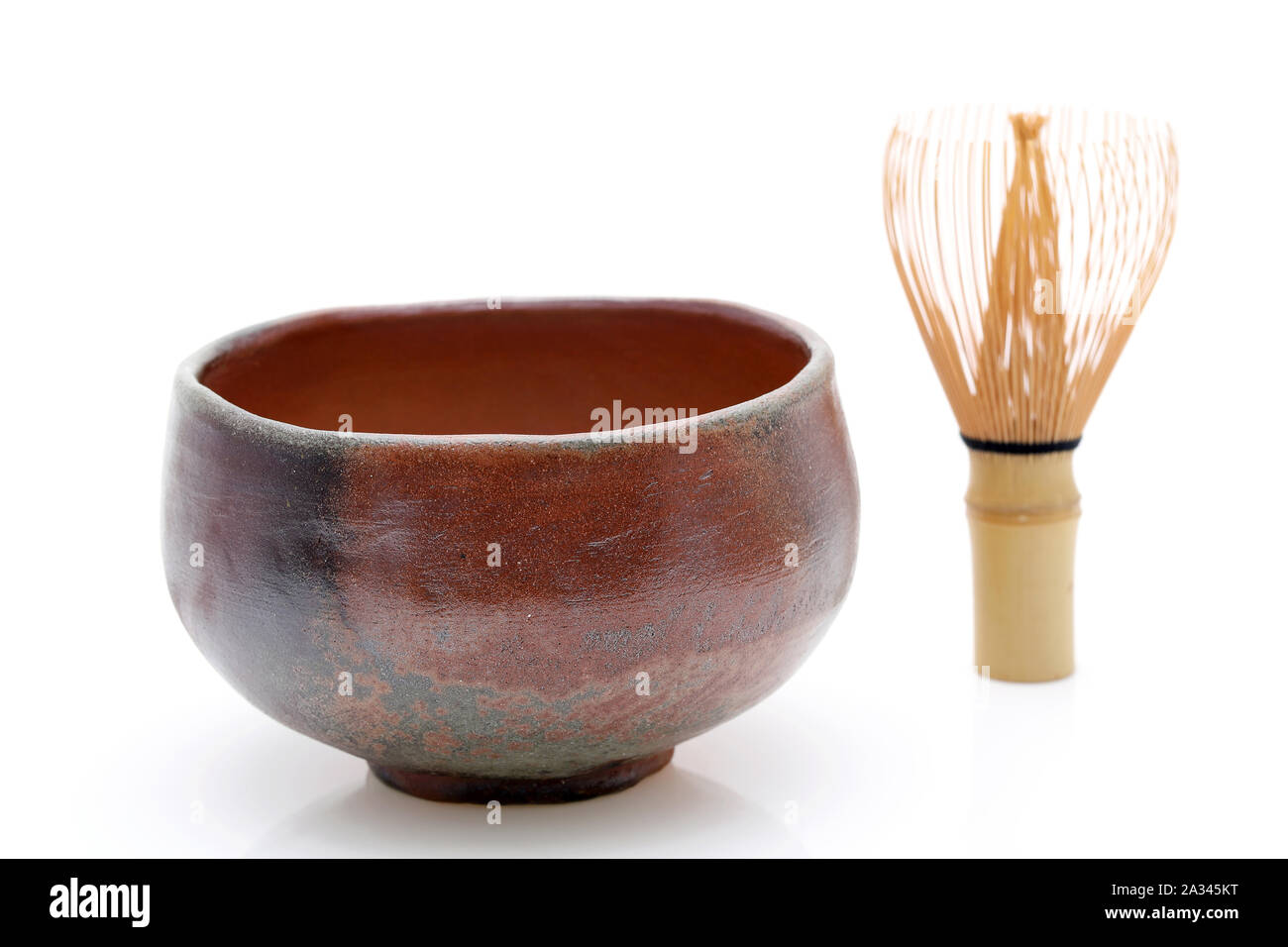 Tea bowl with tea whisk used in Japanese matcha tea ceremony on white hackgrond Stock Photo