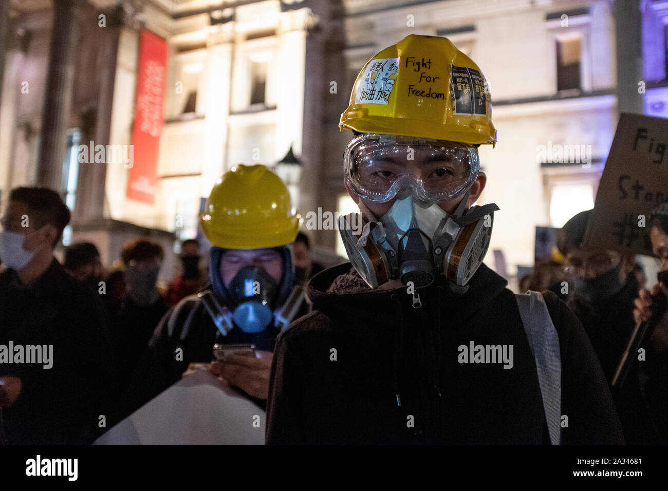 London, UK. 04th Oct, 2019. Protesters seen wearing a yellow helmet, googles and a gas mask during the during the demonstration.Protesters rallied at Trafalgar Square to demand for democracy and justice in Hong Kong and protesting against the implementation of new laws by the Hong Kong government that forbidden to wear masks to protesters in a public protest. Credit: SOPA Images Limited/Alamy Live News Stock Photo