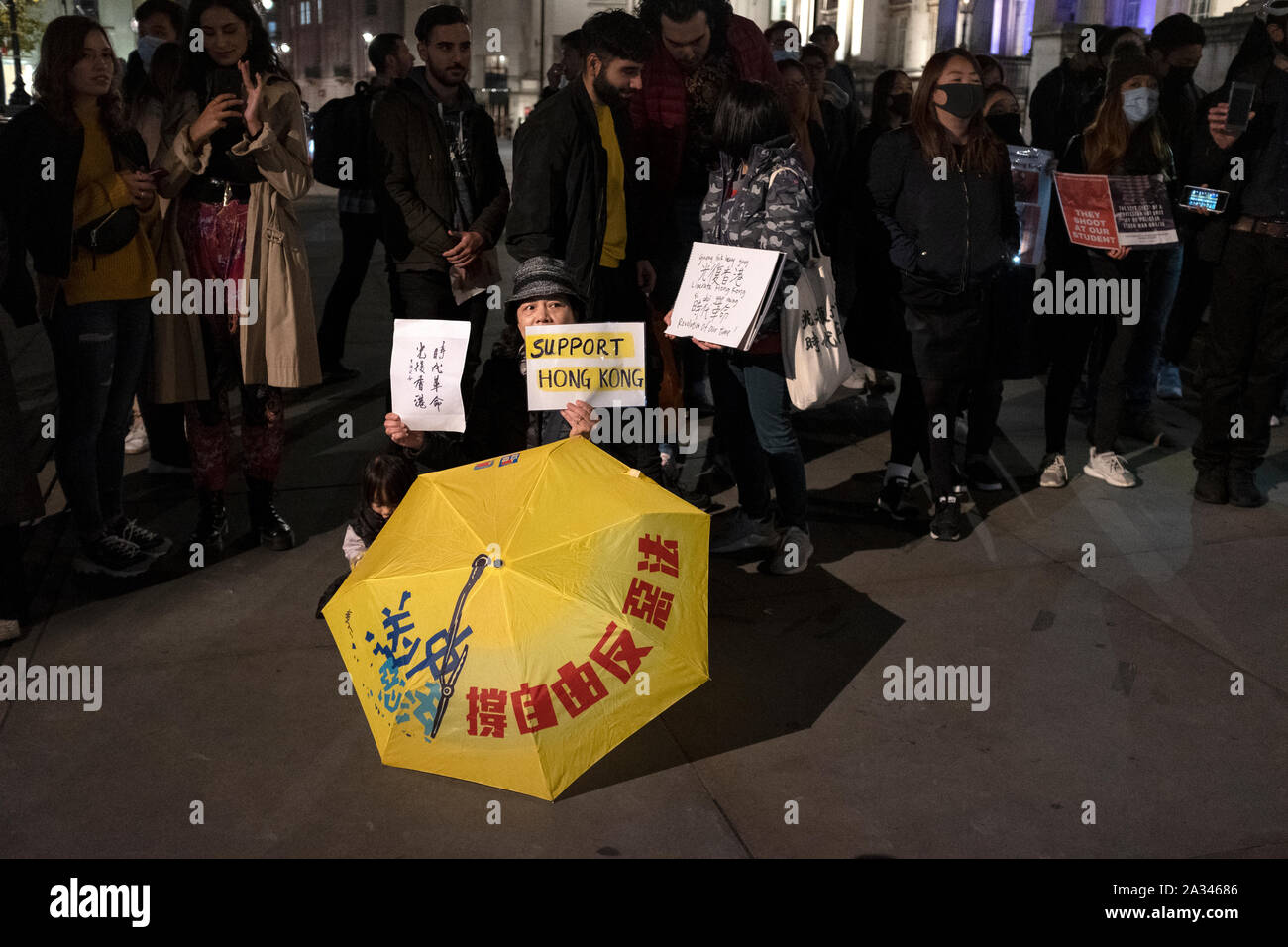 London, UK. 04th Oct, 2019. Protesters hold placards during the demonstration.Protesters rallied at Trafalgar Square to demand for democracy and justice in Hong Kong and protesting against the implementation of new laws by the Hong Kong government that forbidden to wear masks to protesters in a public protest. Credit: SOPA Images Limited/Alamy Live News Stock Photo