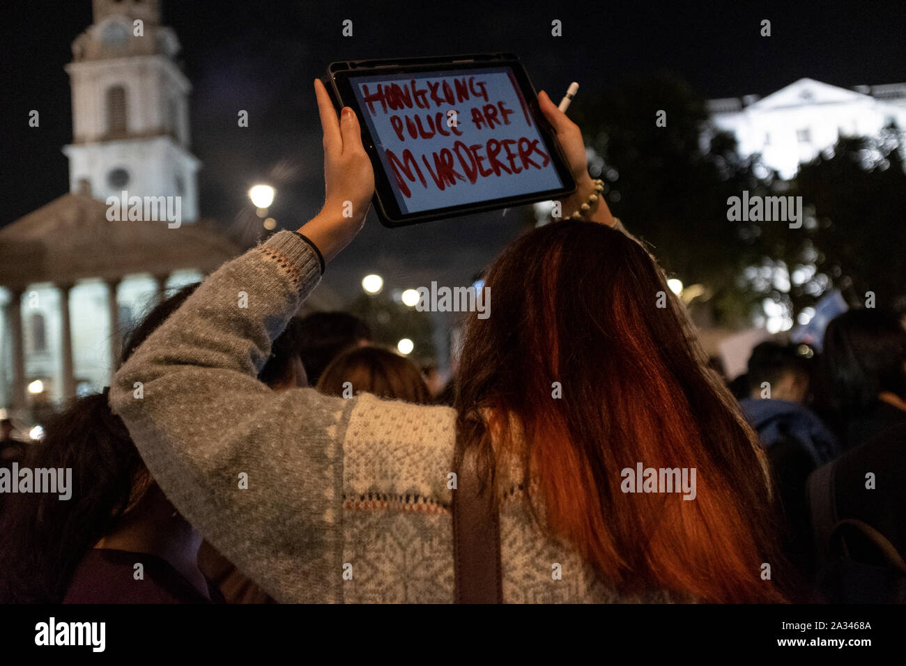 London, UK. 04th Oct, 2019. A protester holds a placard during the demonstration.Protesters rallied at Trafalgar Square to demand for democracy and justice in Hong Kong and protesting against the implementation of new laws by the Hong Kong government that forbidden to wear masks to protesters in a public protest. Credit: SOPA Images Limited/Alamy Live News Stock Photo