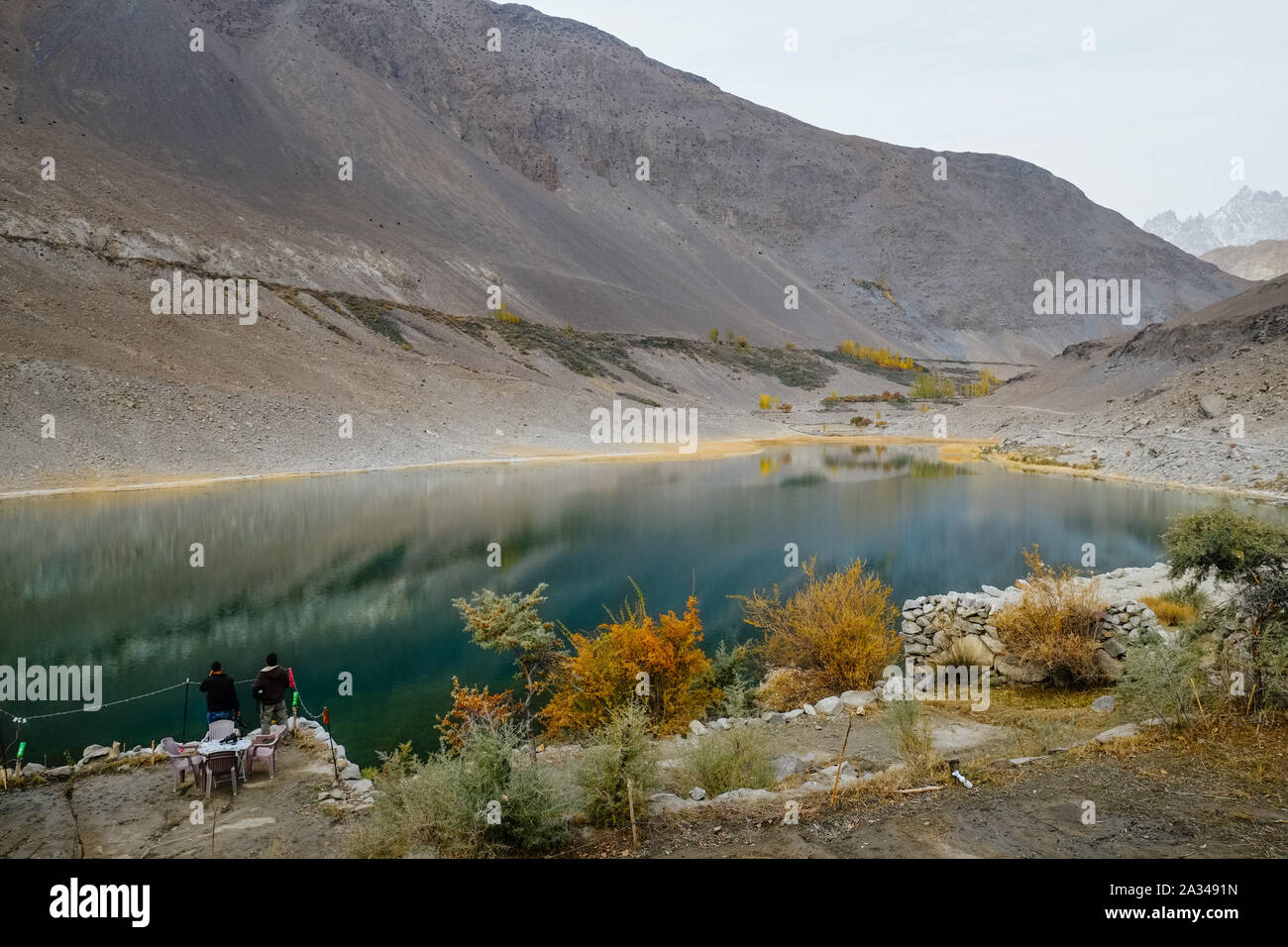 Calmness water in Borith lake against Karakoram mountain range. Autumn season in Gulmit Gojal, Hunza Valley. Gilgit Baltistan, Pakistan. Stock Photo