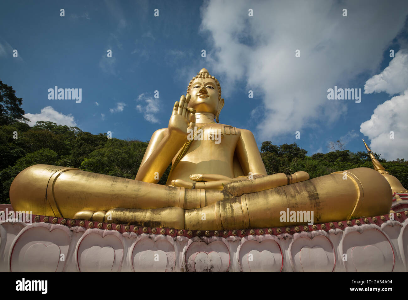 Giant sitting buddha on Rang Hill Temple ( Wat Khao Rang ) with blue sky in Phuket, Thailand Stock Photo
